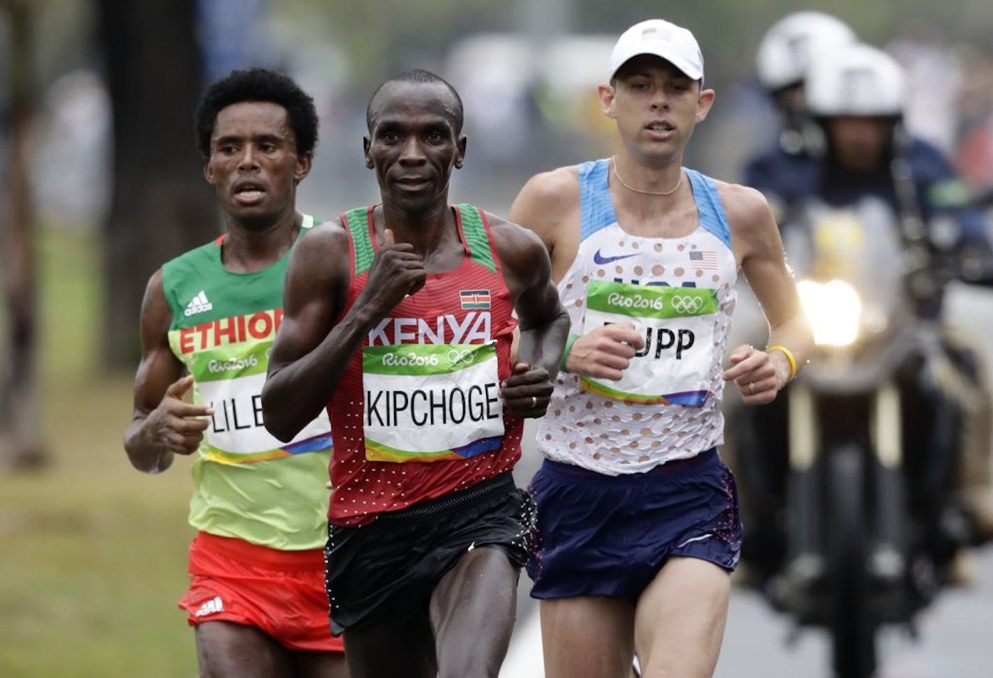 Gold medalist Eliud Kipchoge, of Kenya, center, leads silver medalist Feyisa Lilesa, of Ethiopia, left, and bronze medalist Galen Rupp, of the United States, during the men's marathon at the 2016 Summer Olympics in Rio de Janeiro, Brazil, Sunday, Aug. 21, 2016.