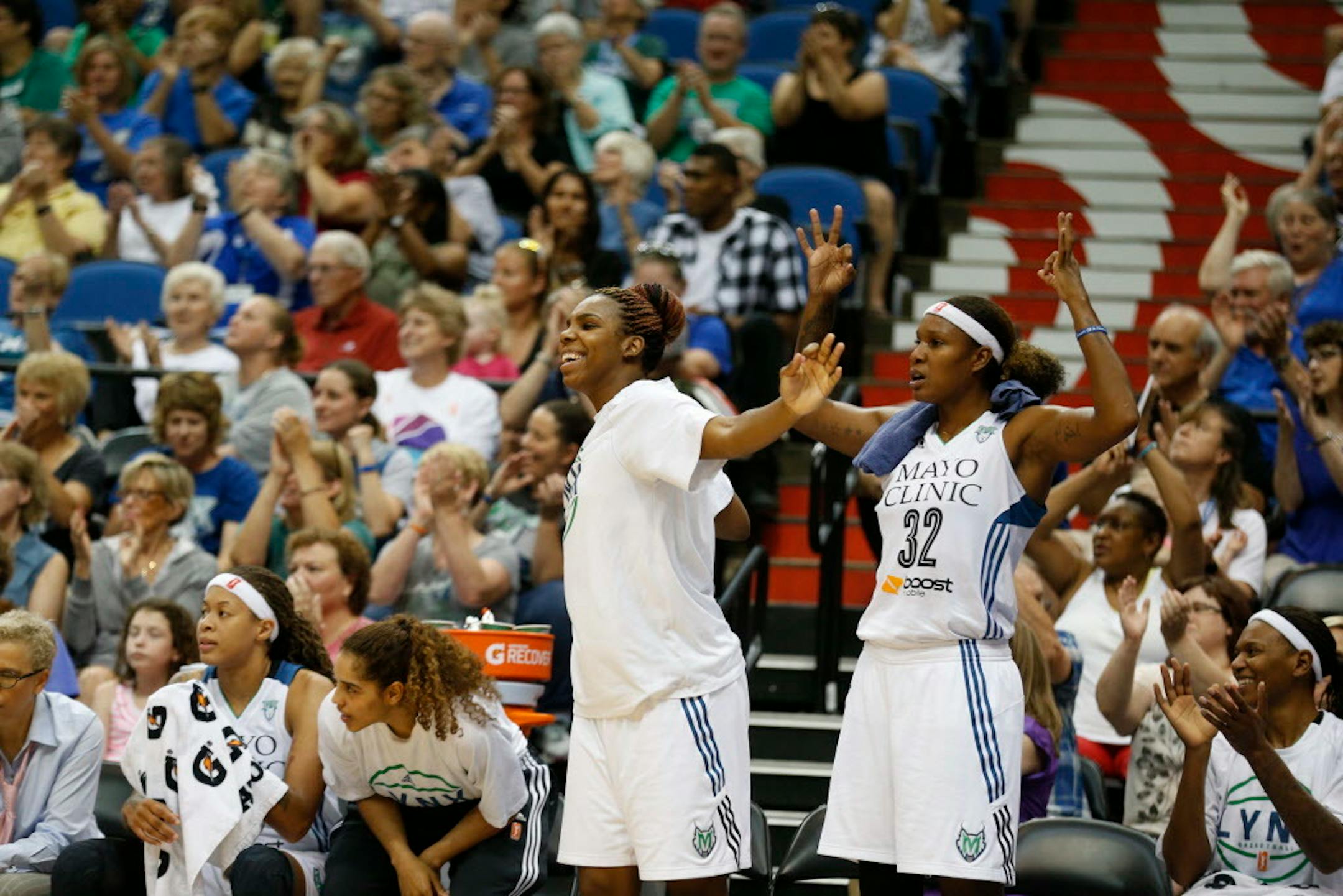Minnesota Lynx forwards Reshanda Gray, left, and Rebekkah Brunson (32) celebrate during the first half of a WNBA basketball game against the San Antonio Stars, Sunday, July 12, 2015, in Minneapolis. The Lynx won 66-49. (AP Photo/Stacy Bengs)