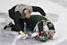 Minnesota Wild's Cal Clutterbuck is tended to by a trainer after being hit by the Oilers' Taylor Hall.