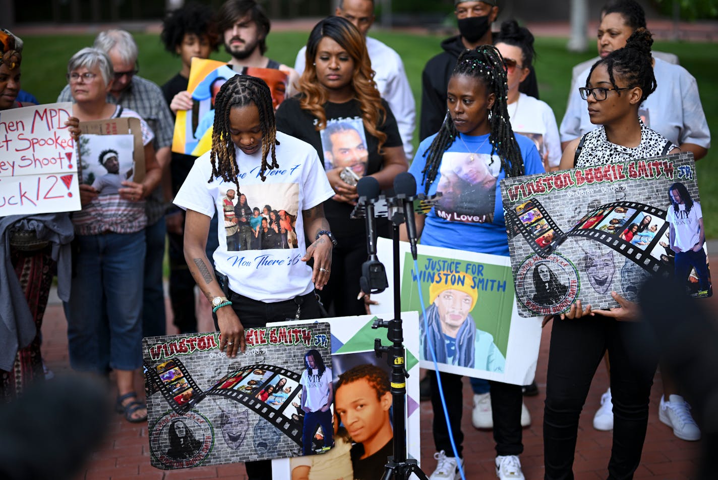 Shatana Cooper, left, of center, held a photo of her brother Winston Smith beside family members at a rally outside the Hennepin County Government Center Friday, June 16, 2023, in Minneapolis, Minn. Smith was shot and killed in an Uptown parking lot in 2021 by a federal task force that included Minneapolis Police and Hennepin County Sheriffs. The US Department of Justice released the findings in its sweeping investigation into the Minneapolis Police Department finding it routinely engaged in a pattern of racist and abusive behavior. ] AARON LAVINSKY • aaron.lavinsky@startribune.com