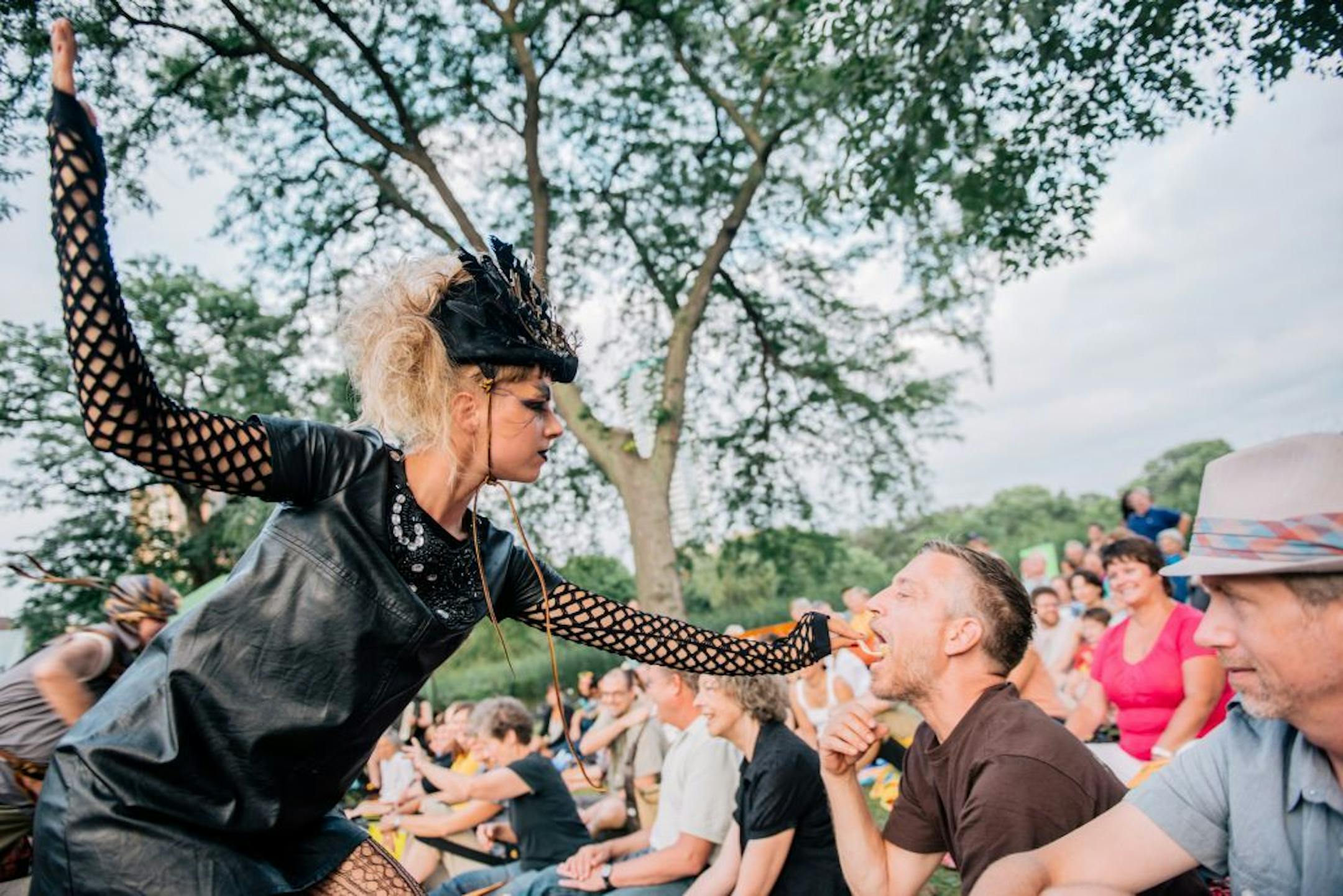 A performer fed an audience member at Picnic Operetta.
