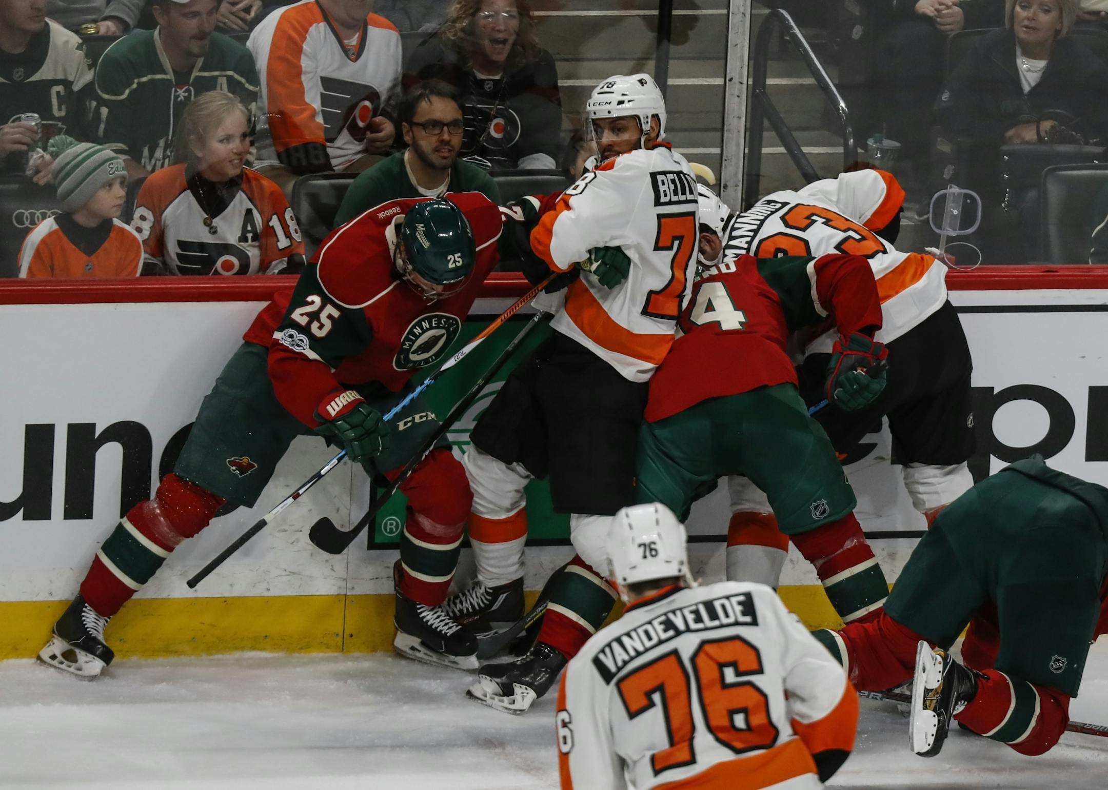 Both teams piled up at the boards fighting for the puck during an unsuccessful Wild power play in the second period.