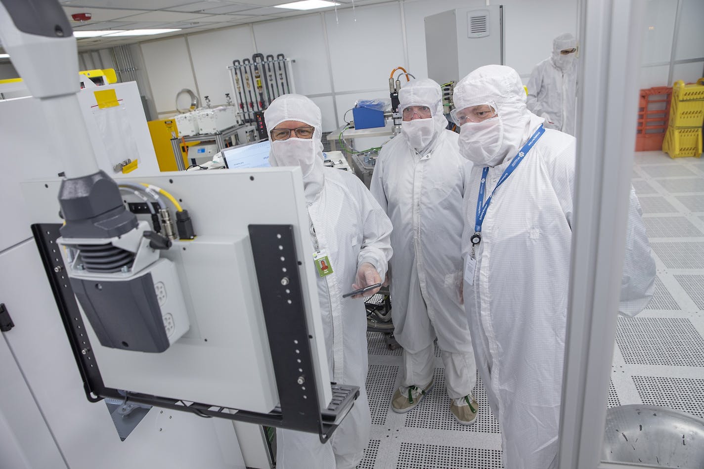 Skywater Technology's Director of Production Eric Schneider, right, looked over the new equipment that was being installed at Minnesota's biggest chip plant, May 22 in Bloomington. Photo by Elizabeth Flores, liz.flores@startribune.com. ORG XMIT: MIN1905231310171958