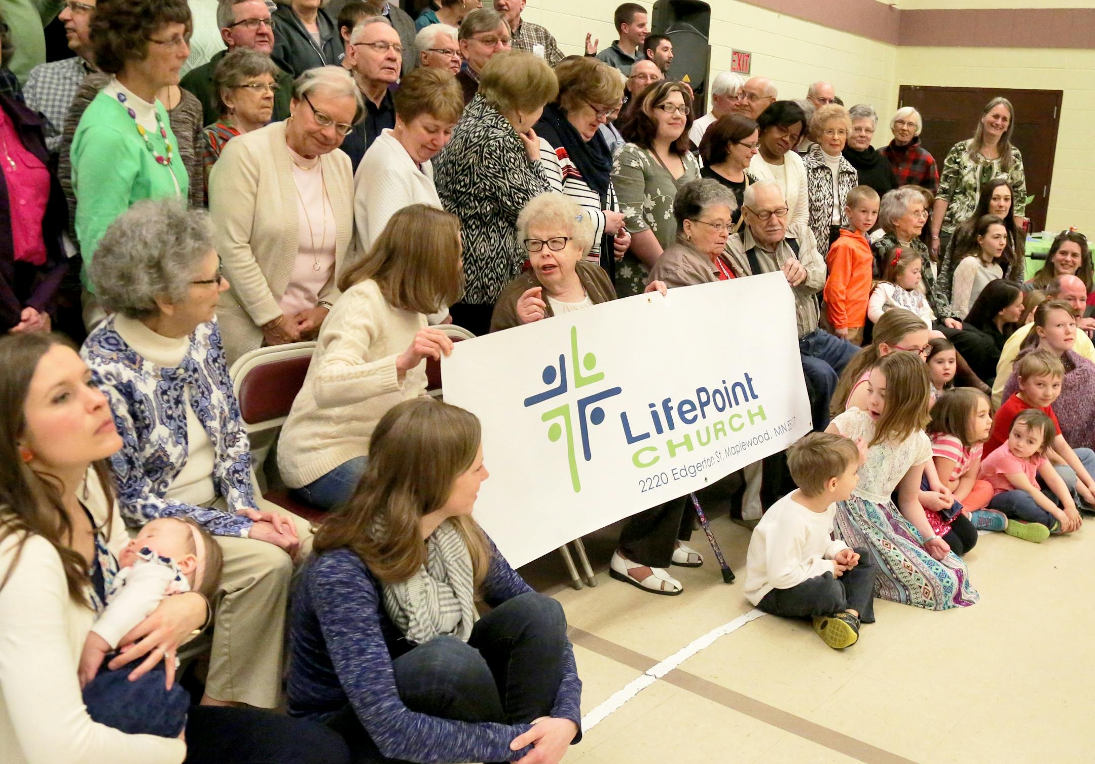Church members gather for a photo following a ceremony entitled: Honoring the Past, Preparing for the Future: Trinity Baptist Church becomes LifePoint Church Saturday, April 1, 2017, in St. Paul, MN.