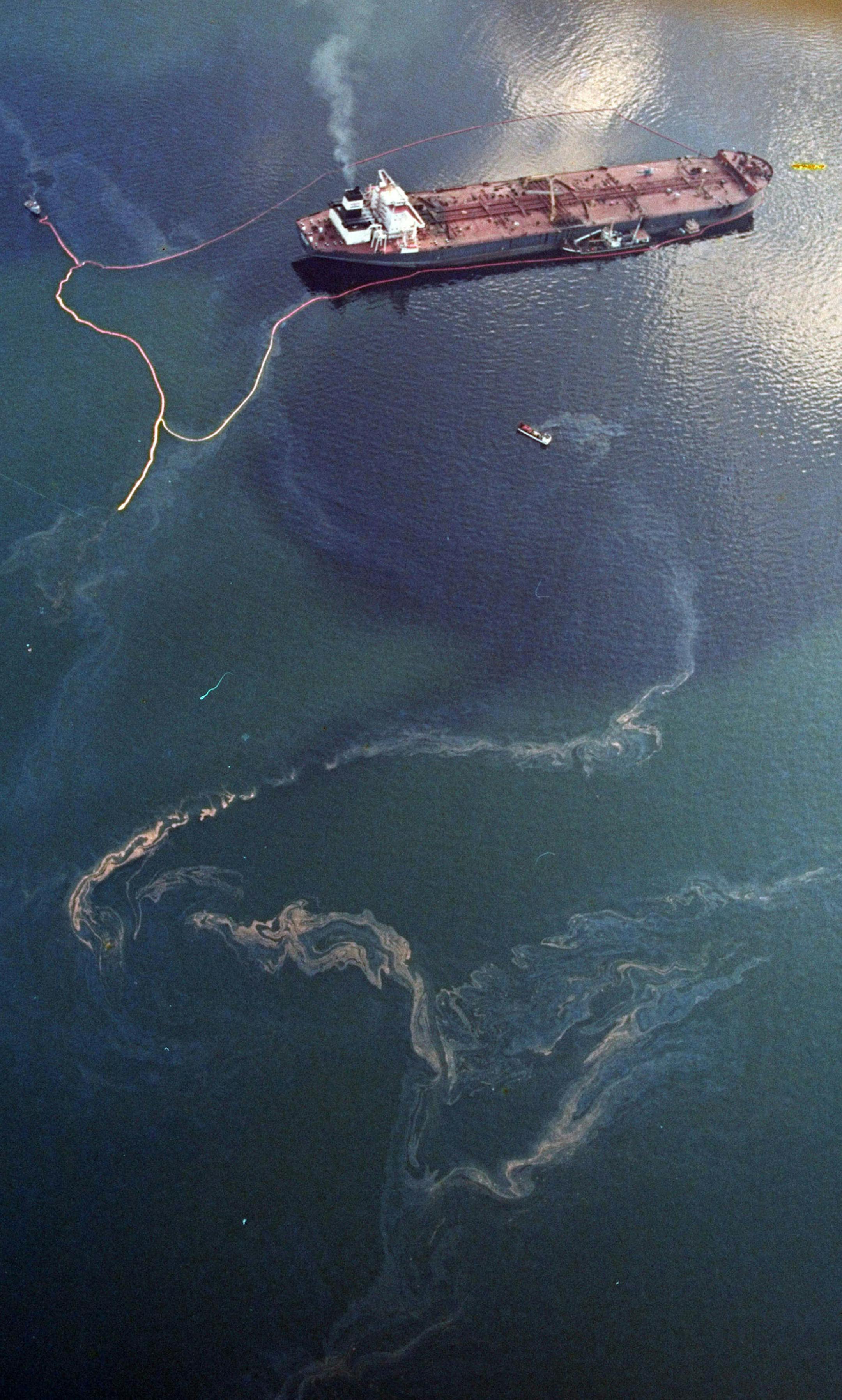 FILE - In this April 9, 1989 file photo, crude oil from the tanker Exxon Valdez, top, swirls on the surface of Alaska's Prince William Sound near Naked Island. The 987-foot tanker, carrying 53 million gallons of crude, struck Bligh Reef at 12:04 a.m. on March 24, 1989, and within hours unleashed an estimated 10.8 million gallons of thick, toxic crude oil into the water. Storms and currents then smeared it over 1,300 miles of shoreline. Twenty five years later, the region, its people and its wild