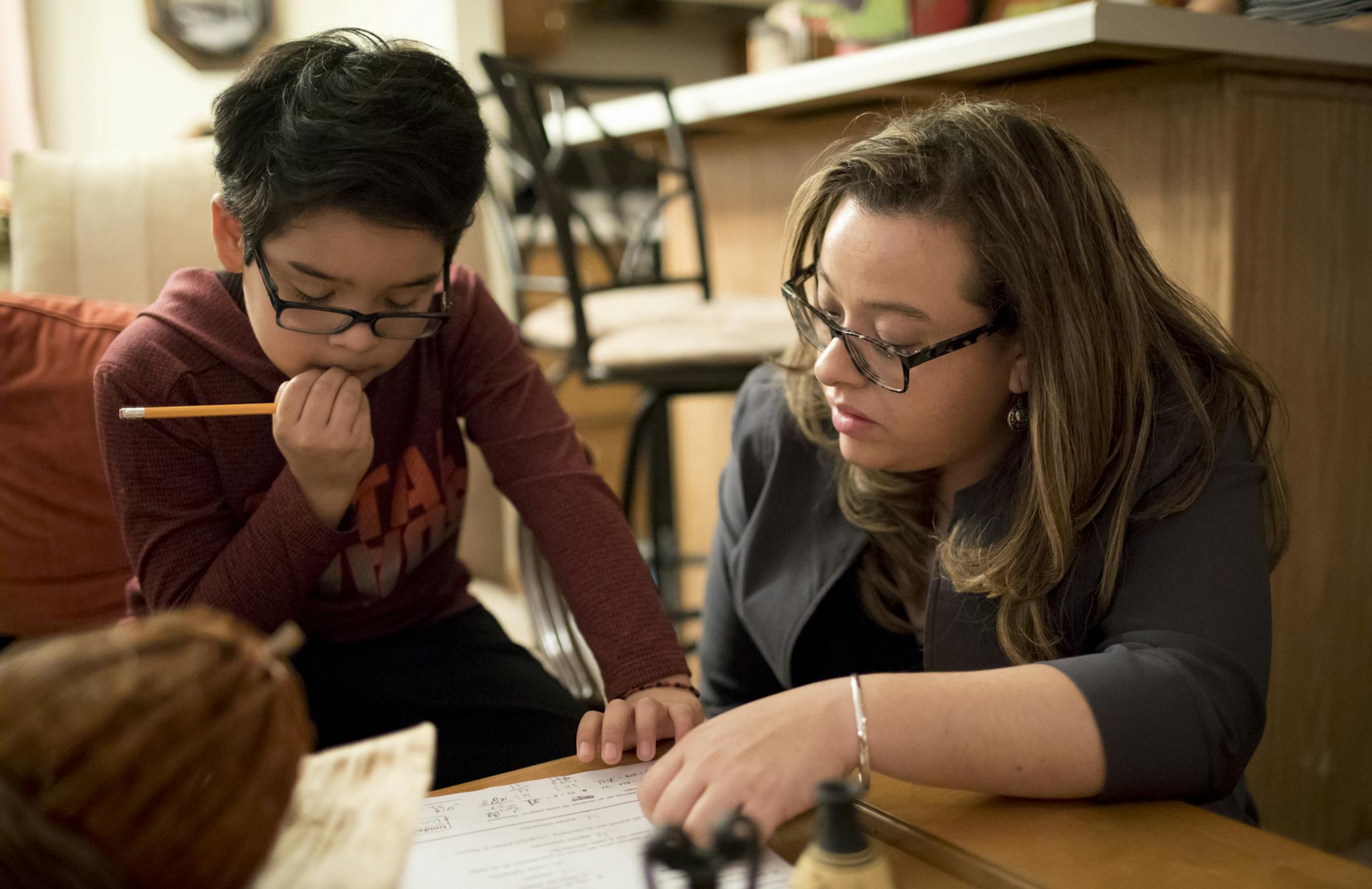 Ana Blee, a DACA recipient from Hopkins, finds herself in double limbo: She is waiting to find out if the government will approve a DACA renewal application she scrambled to put in last week after a court ordered the administration to resume taking such applications. She helped her son Alexander Blee, 8, with his math homework at home on Wednesday, January 24, 2018 in Hopkins, Minn. ] RENEE JONES SCHNEIDER • renee.jones@startribune.com