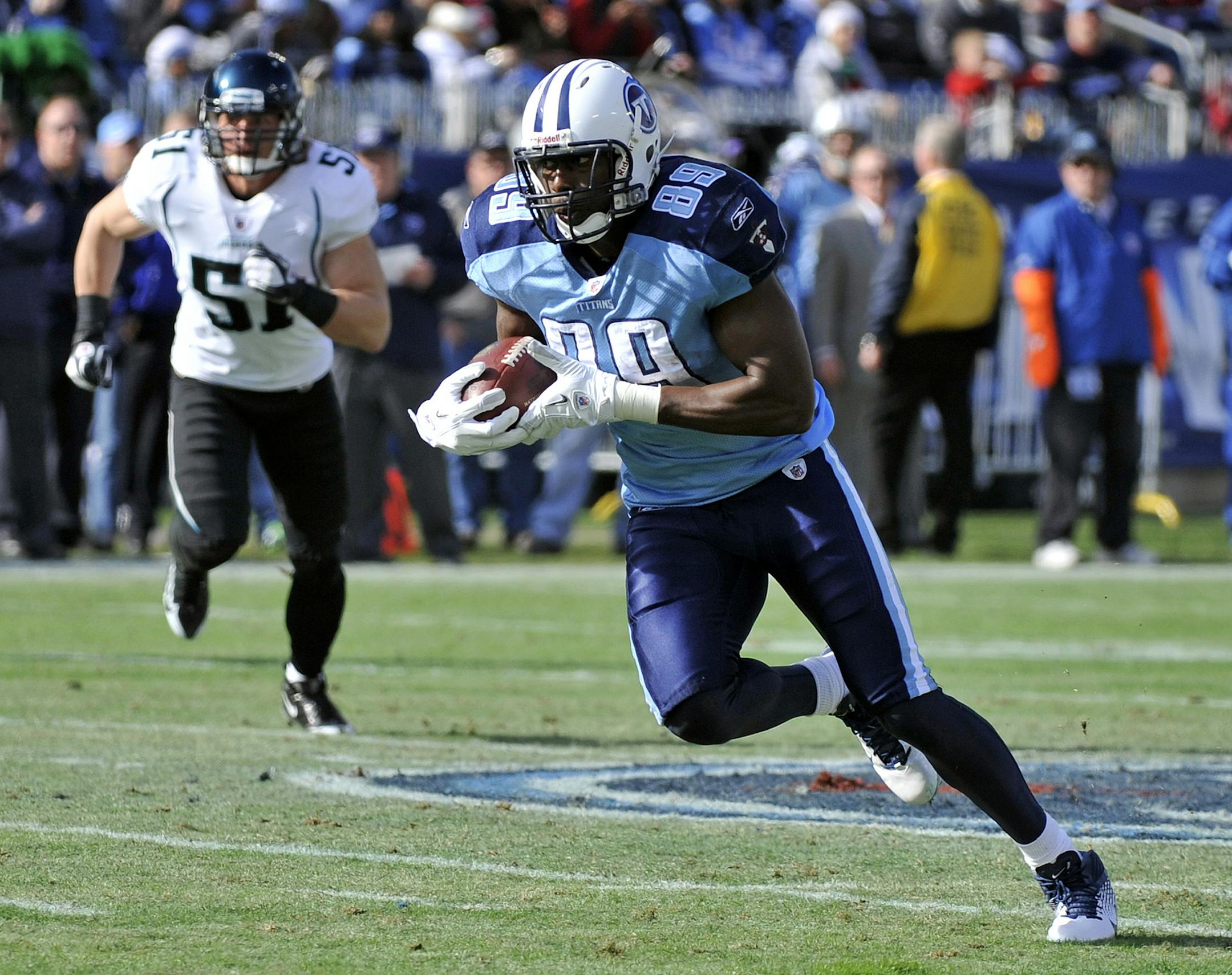 Tennessee Titans tight end Jared Cook (89) is chased by Jacksonville Jaguars middle linebacker Paul Posluszny (51) after Cook caught a pass in the first quarter of an NFL football game on Saturday, Dec. 24, 2011, in Nashville, Tenn. Cook caught eight passes for 169 yards and one touchdown as the Titans won 23-17. (AP Photo/Frederick Breedon)