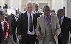 FILE - In this May, 10, 2010, file photo, Roy Bennett, center left, leaves the High Court in Harare, Zimbabwe, after he was acquitted of terrorism cha