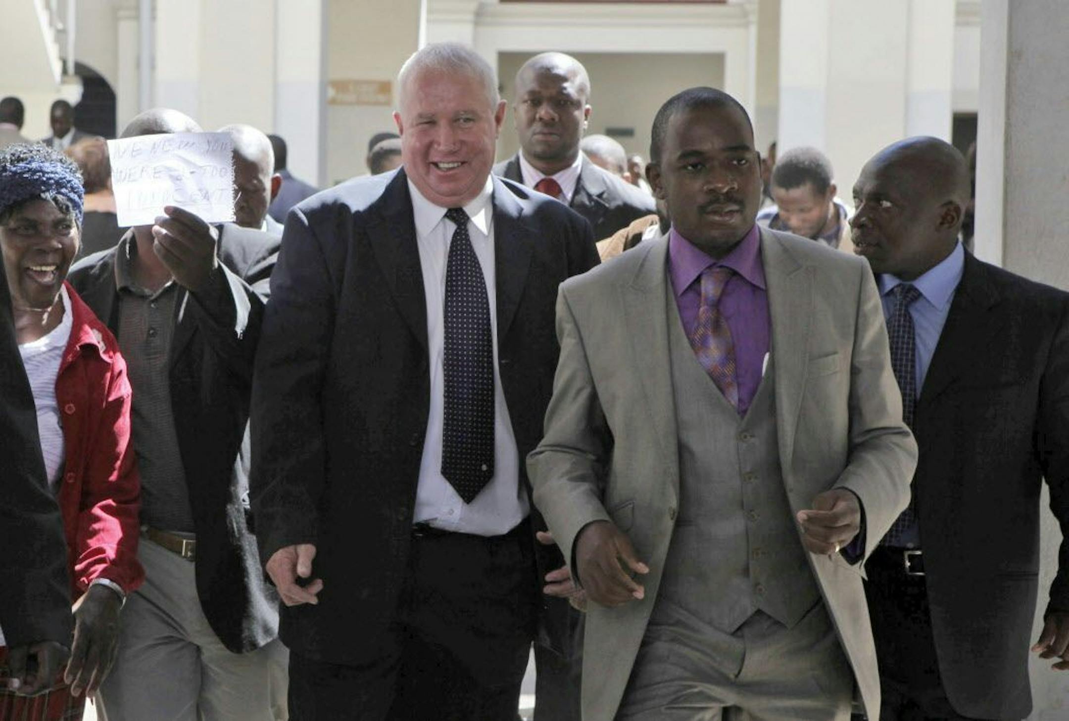 FILE - In this May, 10, 2010, file photo, Roy Bennett, center left, leaves the High Court in Harare, Zimbabwe, after he was acquitted of terrorism charges. New Mexico State Police said Thursday, Jan. 18 2018, that Zimbabwean opposition leader Roy Bennett died in helicopter crash. The crash on Wednesday, Jan. 17, carrying Bennett and five others went down in a mountainous rural area of northern New Mexico.