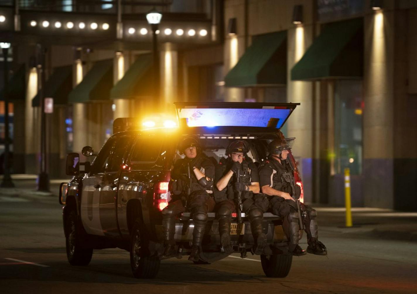 State Patrol officers enforcing curfew rode in the back of a State Patrol truck in downtown Minneapolis almost two hours after curfew began on Thursday, Aug. 27.