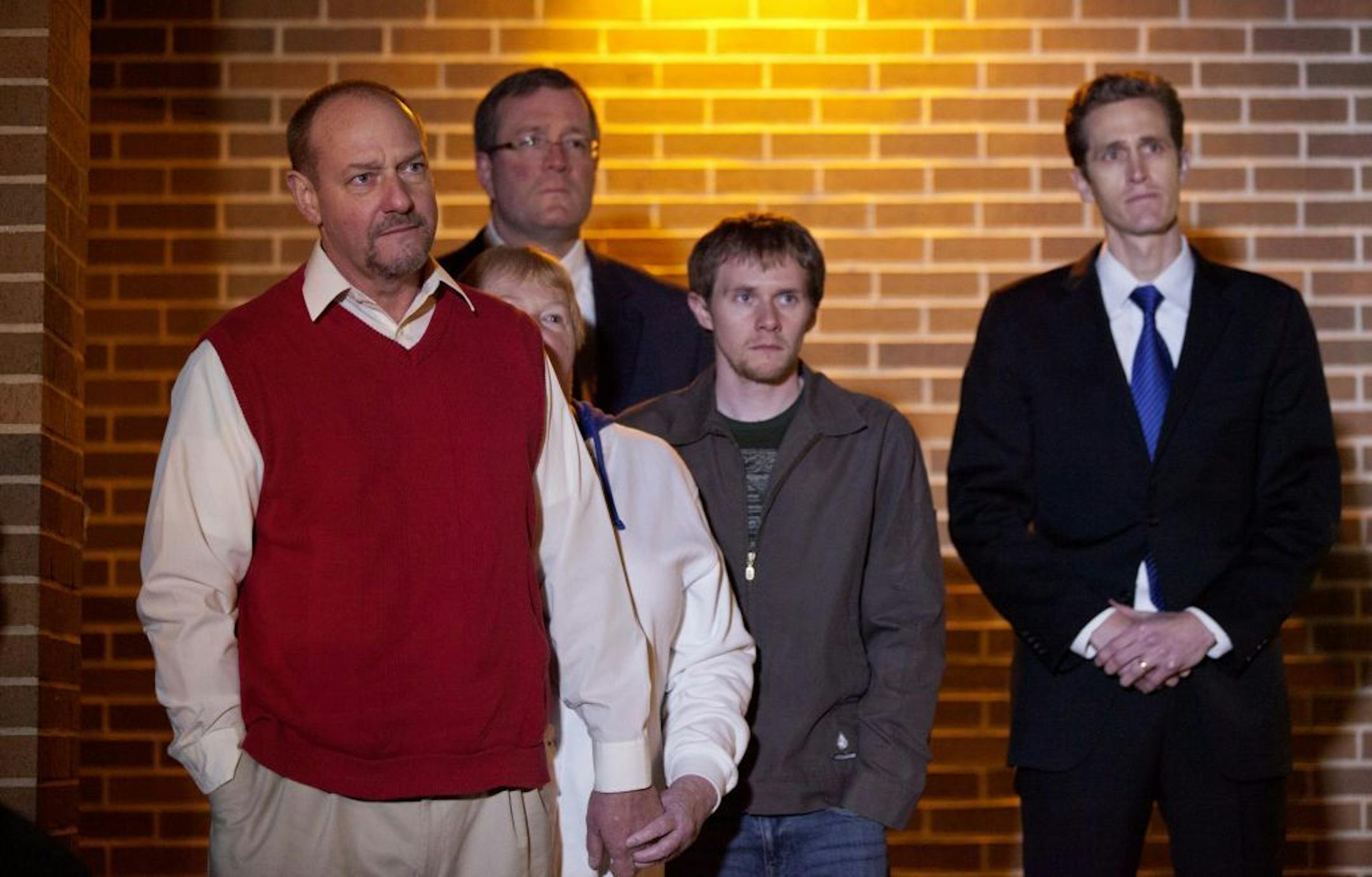 Randy Parker, left, stands with his wife Karen as their son, Robbie Parker, not pictured, the father of six-year-old Emilie who was killed in the Sandy Hook Elementary School shooting, speaks at a press conference outside the Church of Jesus Christ of Latter Day Saints, Saturday, Dec. 15, 2012, in Newtown, Conn.