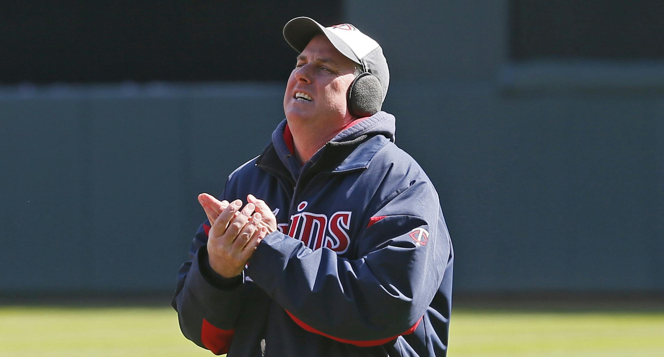 Larry DiVito Minnesota Twins head groundkeeper sprayed try to warm his has after watering the infield at Target Field , Sunday March, 31, 2013 in Minneapolis, MN. Twins fans was face cold temps on Monday during the opener with Detroit. ] JERRY HOLT ‚Ä¢ jerry.holt@startribune.com