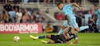 Minnesota United midfielder Franco Fragapane (7) went over the top of Los Angeles Galaxy defender Julian Araujo (2) as he raced for the ball in the fi