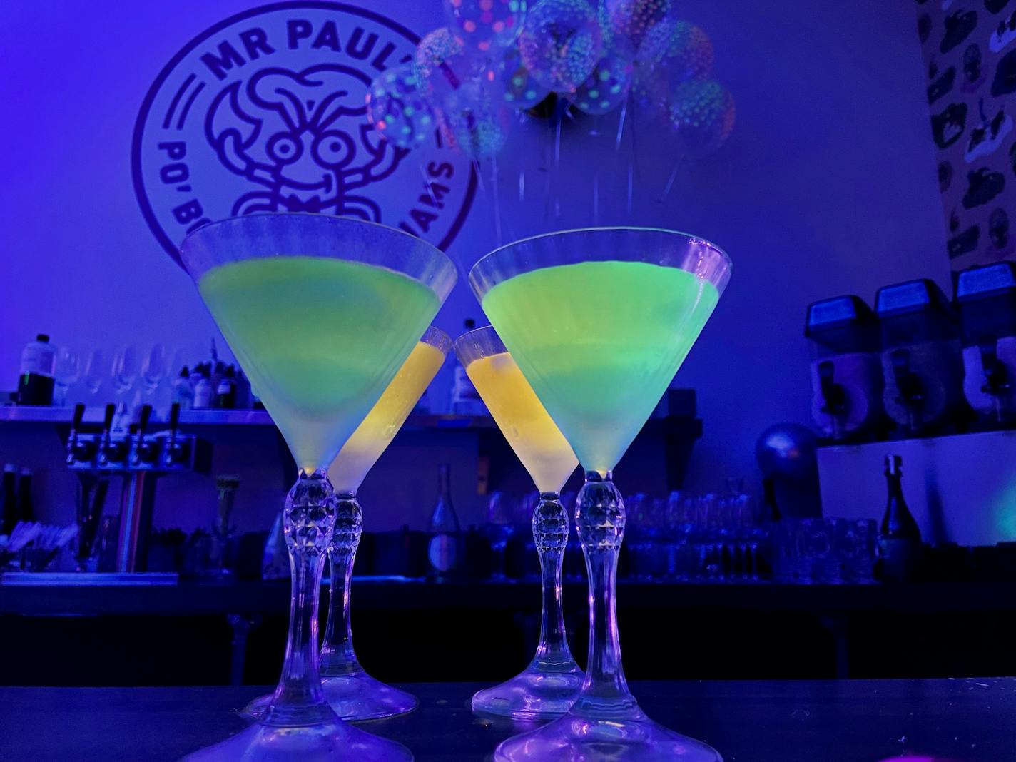 Neon drinks glow on the bar at the Balloon Emporium, a ticketed cocktail tasting weekends at Mr. Paul's Supper Club.