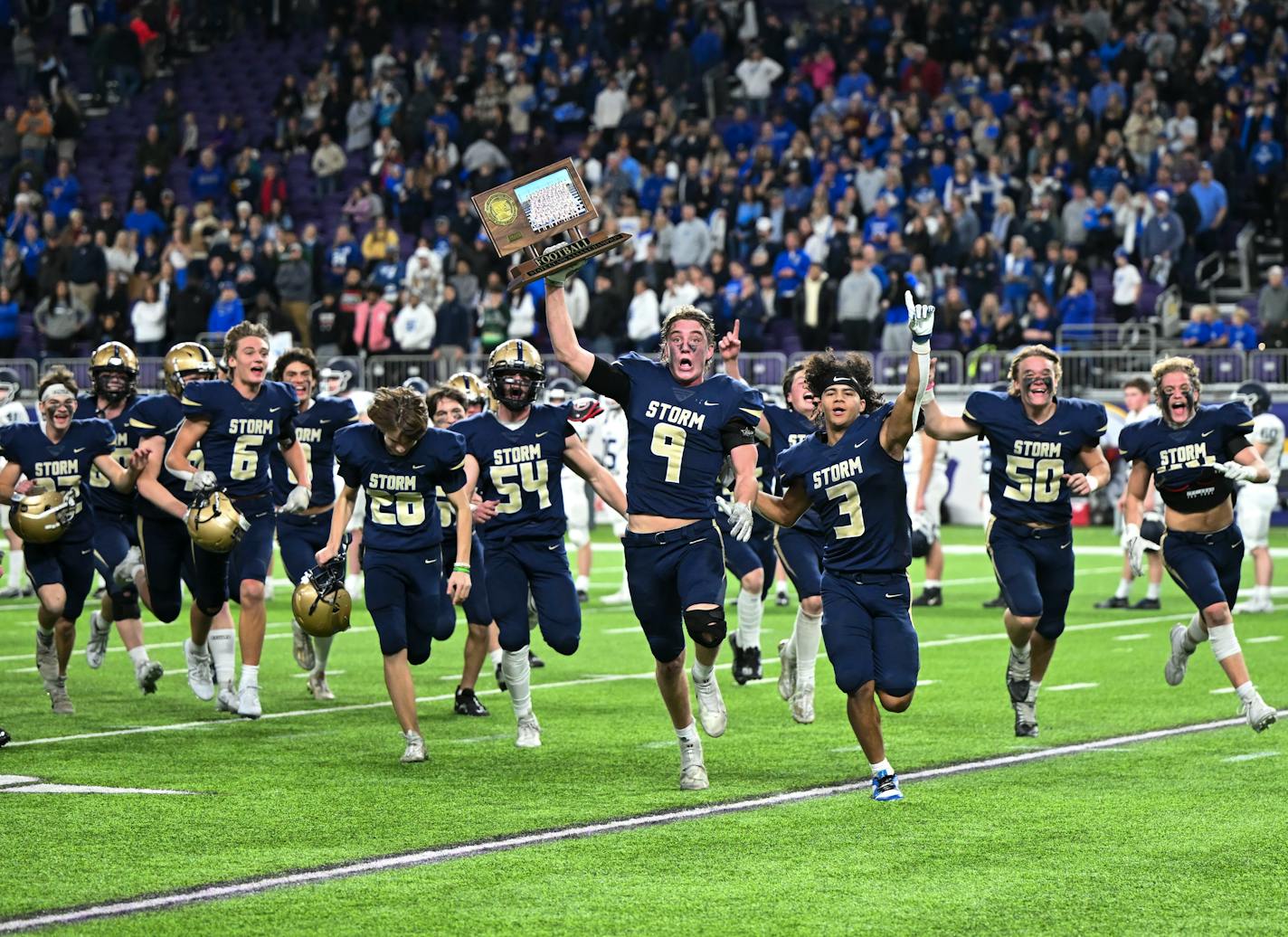 Chanhassen players, including Sam Macy (9), celebrate their win in the Class 5A football state championship game Saturday, Nov. 25, 2023 at U.S. Bank Stadium in Minneapolis, Minn.. ] AARON LAVINSKY • aaron.lavinsky@startribune.com