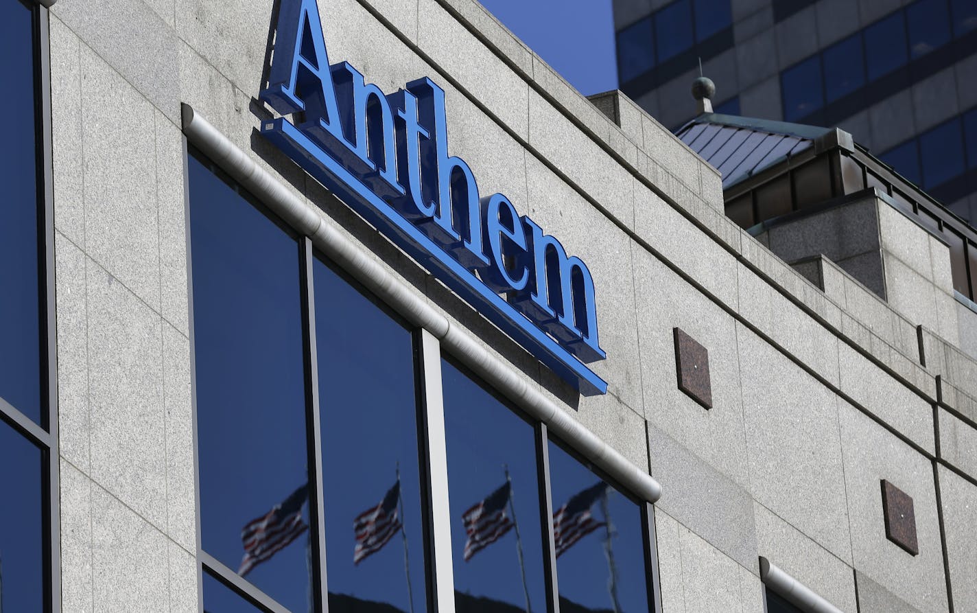 The Anthem logo hangs at the health insurer's corporate headquarters in Indianapolis, Thursday, Feb. 5, 2015. Hackers broke into the company's database storing information for about 80 million people in an attack bound to stoke fears many Americans have about the privacy of their most sensitive information. (AP Photo/Michael Conroy)