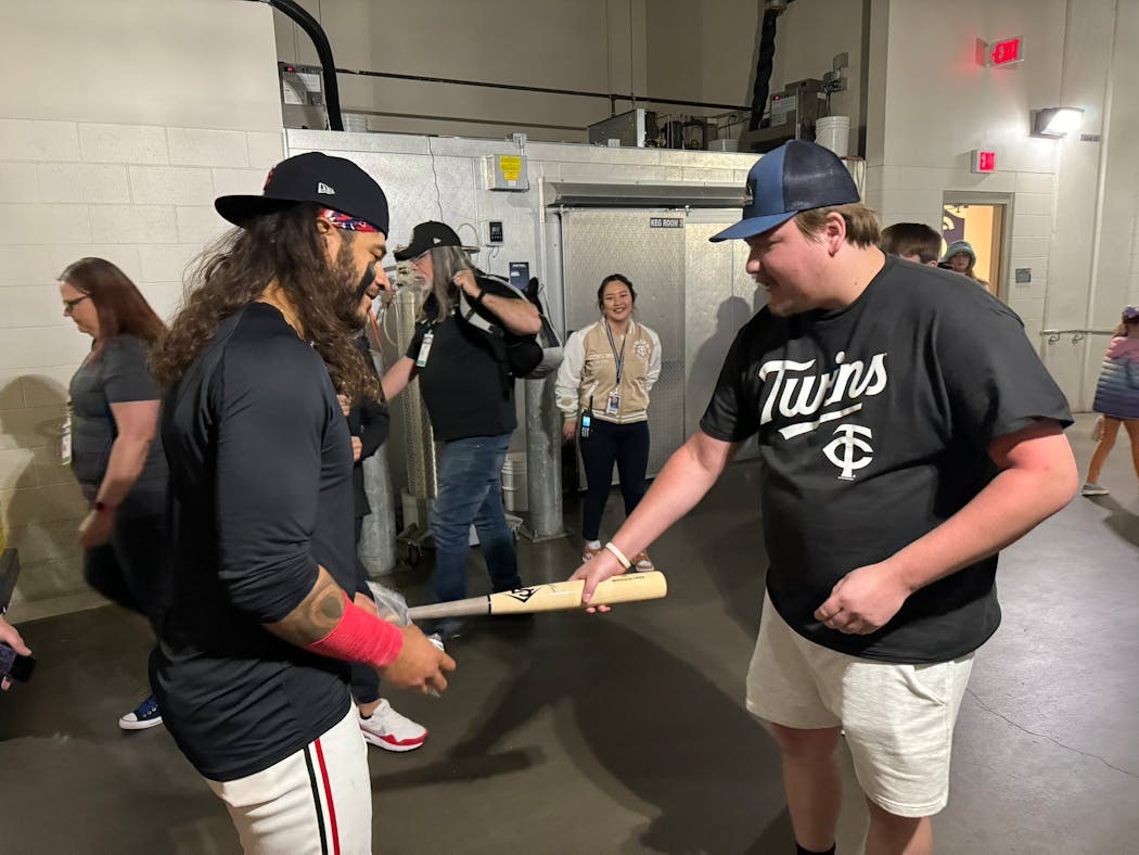 Twins rookie Austin Martin trades a signed bat with the fan that caught his first home run ball at Target Field on Sunday.