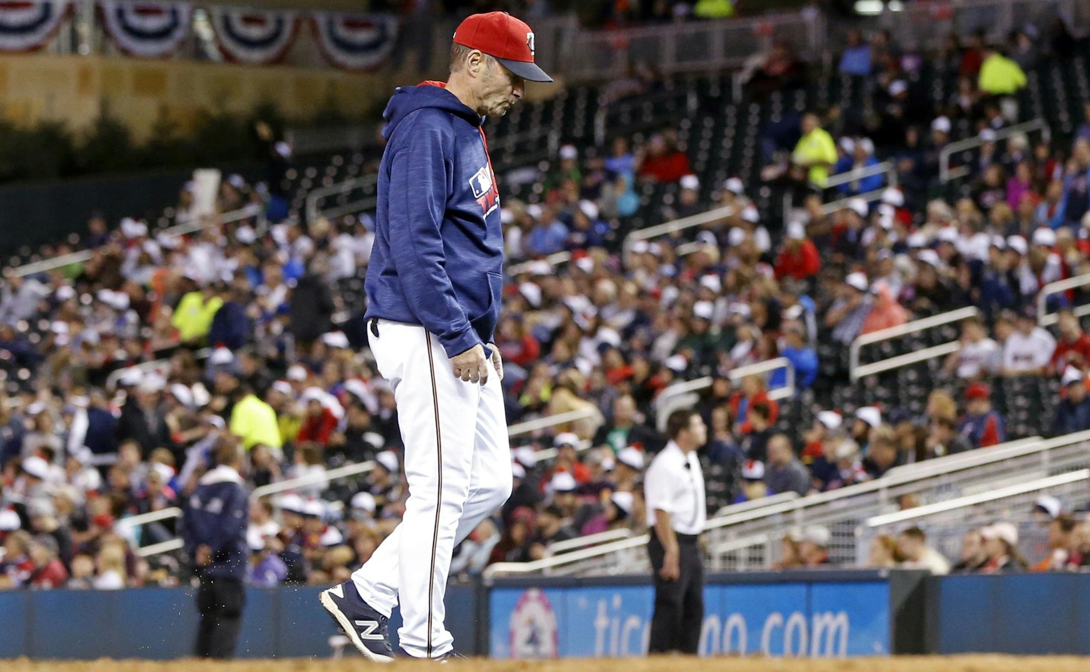 Minnesota Twins manager Paul Molitor walks back to the dugout after one of three pitching changes during the seventh inning of a baseball game against the Seattle Mariners Friday, Sept. 23, 2016, in Minneapolis. The Mariners won 10-1. (AP Photo/Jim Mone)