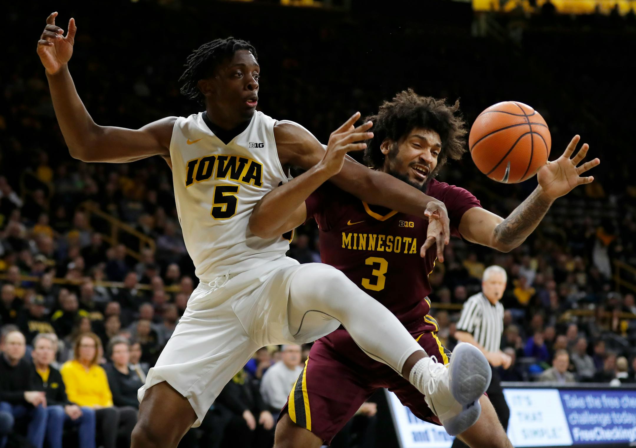 Iowa forward Tyler Cook, left, fights for a rebound with Minnesota forward Jordan Murphy (3) during the first half of an NCAA college basketball game, Tuesday, Jan. 30, 2018, in Iowa City, Iowa. (AP Photo/Charlie Neibergall)