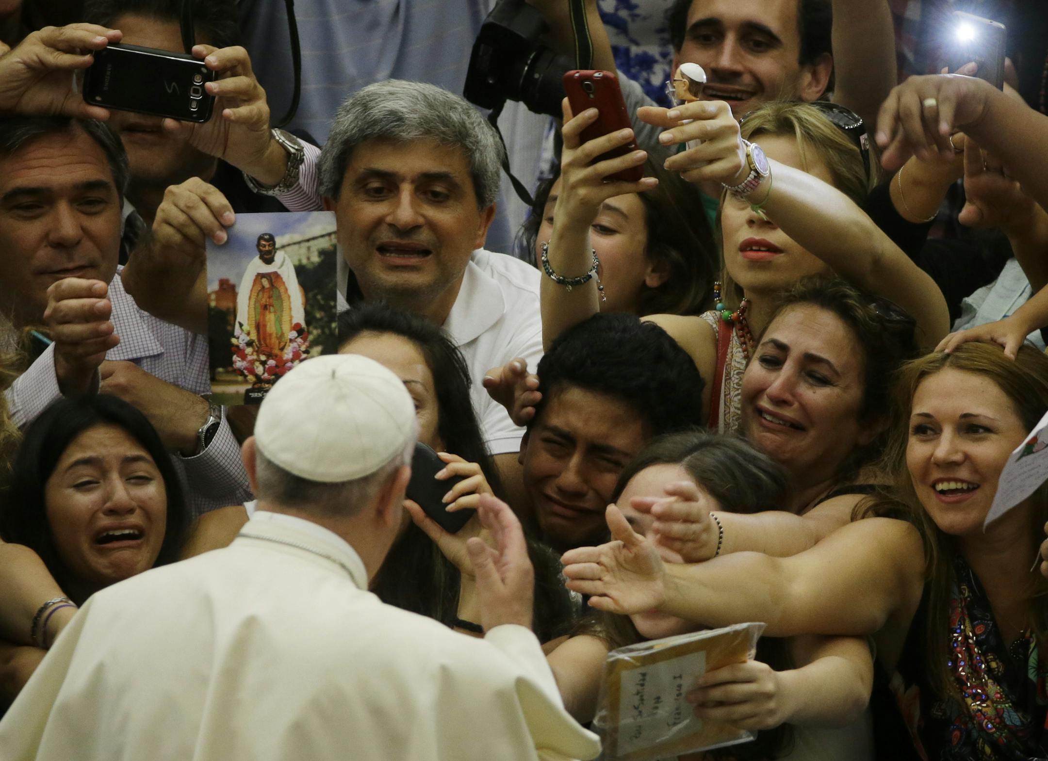 Pope Francis is cheered by faithful as he arrives in the Paul VI hall at the Vatican, Wednesday, Aug. 5, 2015. (AP Photo/Gregorio Borgia)
