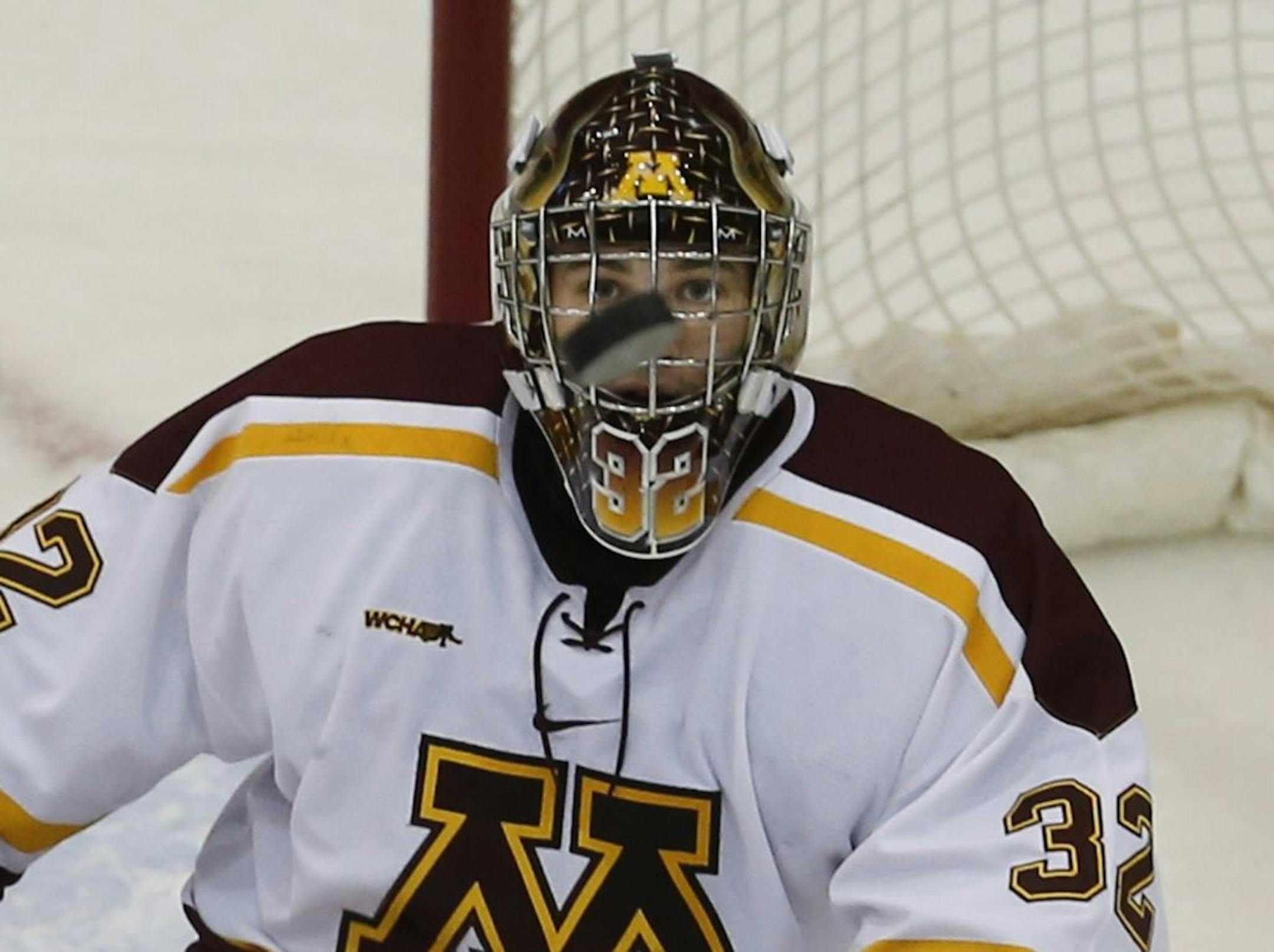 Minnesota goalie Adam Wilcox (32) eyes the puck on a save against Wisconsin during first period action Friday, Nov. 16, 2012, at Mariucci Arena at the University of Minnesota in Minneapolis, MN.