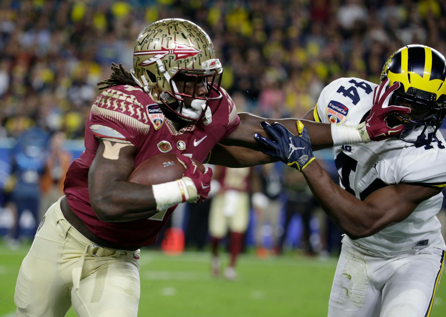 FILE - This Dec. 30, 2016, file photo shows Michigan safety Delano Hill, right, attempting to stop Florida State running back Dalvin Cook, left, during the first half of the Orange Bowl NCAA college football game in Miami Gardens, Fla. The NFL Draft will be held April 27-29, 2017, in Philadelphia.(AP Photo/Lynne Sladky, File)