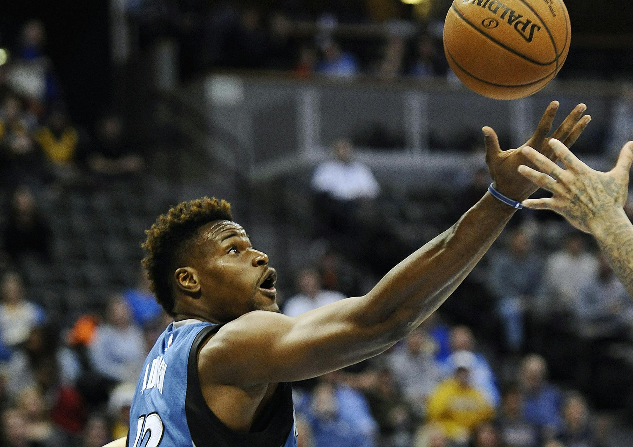 Minnesota Timberwolves forward Jeff Adrien tries to grab a rebound during the second half of an NBA basketball game against the Denver Nuggets on Friday, Dec. 26, 2014, in Denver. The Nuggets won 106-102. (AP Photo/Chris Schneider)