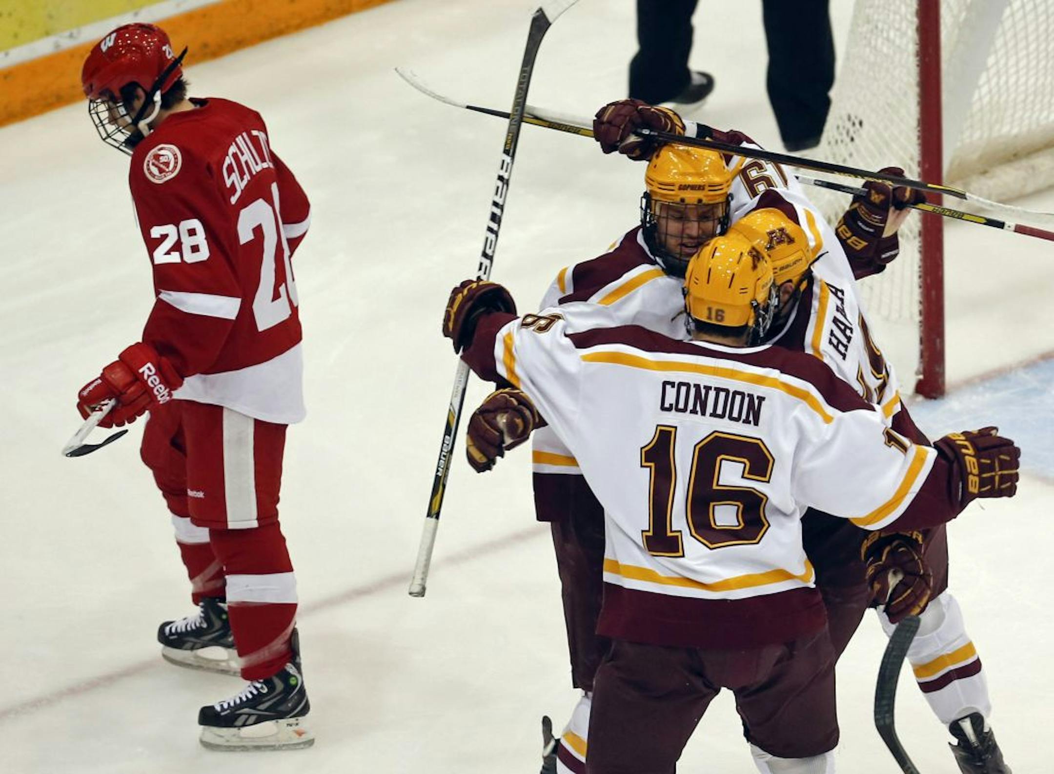 Minnesota's Nate Condon (16) and Erik Haula (19) celebrate a first period goal by Minnesota's Zach Budish, middle, as Wisconsin's Kevin Schulze (28) skates off during action Friday, Nov. 16, 2012, at Mariucci Arena at the University of Minnesota in Minneapolis, MN.