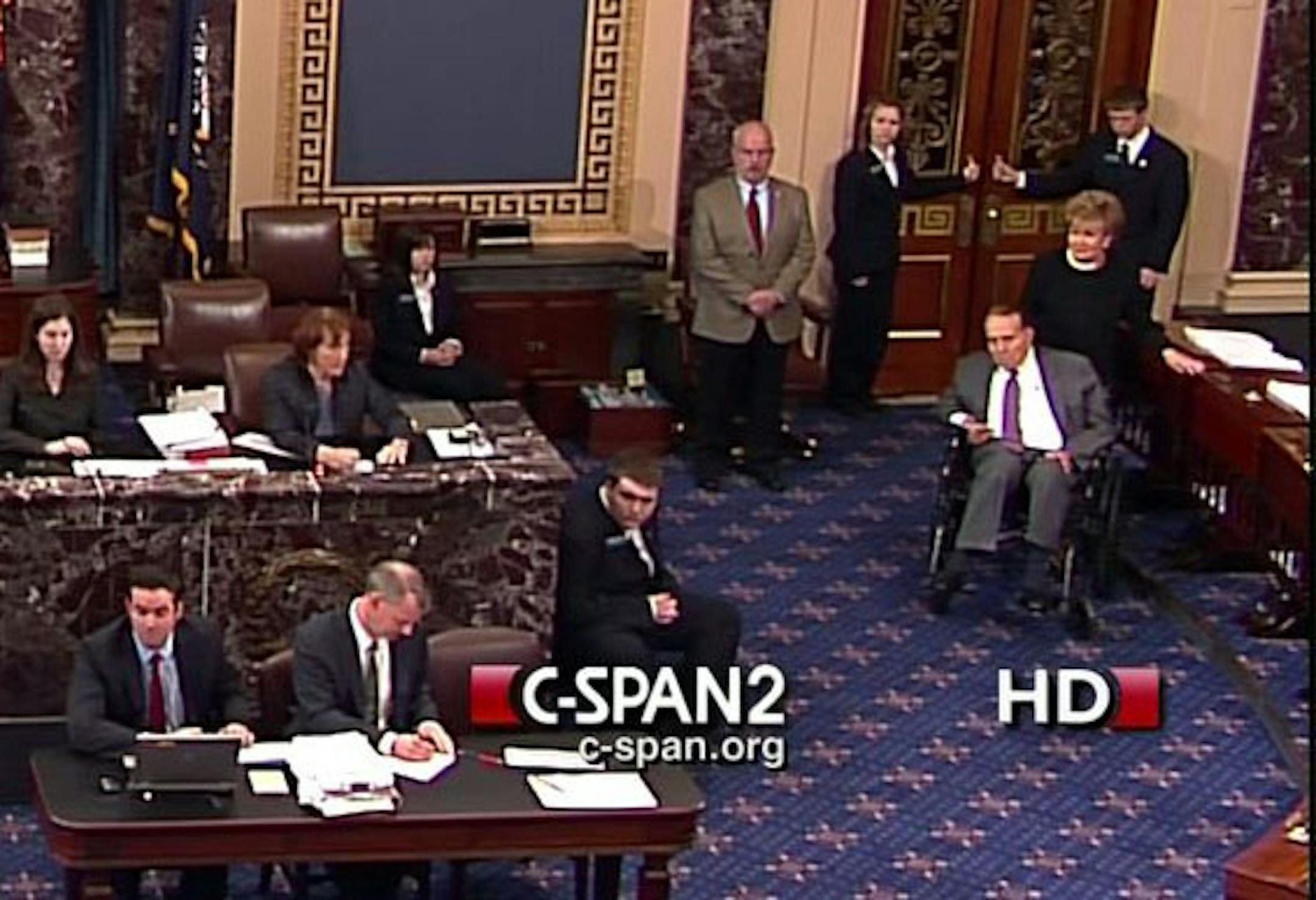 This screenshot image from CSPAN2 shows former Senate Majority Leader Bob Dole, right, wheeled into the Senate Chamber on Capitol Hill in Washington, Tuesday, Dec. 4,2012, by his wife Elizabeth Dole. Frail and in a wheelchair, Dole was a startling presence on the Senate floor as lawmakers voted on a treaty on disabilities.