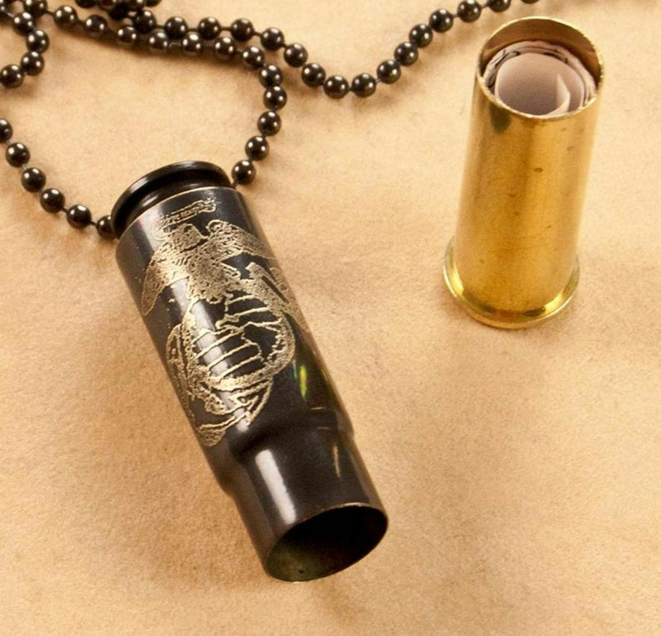 In this photo are some components of the necklace that was taken at airport security featuring a bullet casing with a personal engraving on it and, tucked inside, a letter from his girlfriend. Credit: Janelle Verke