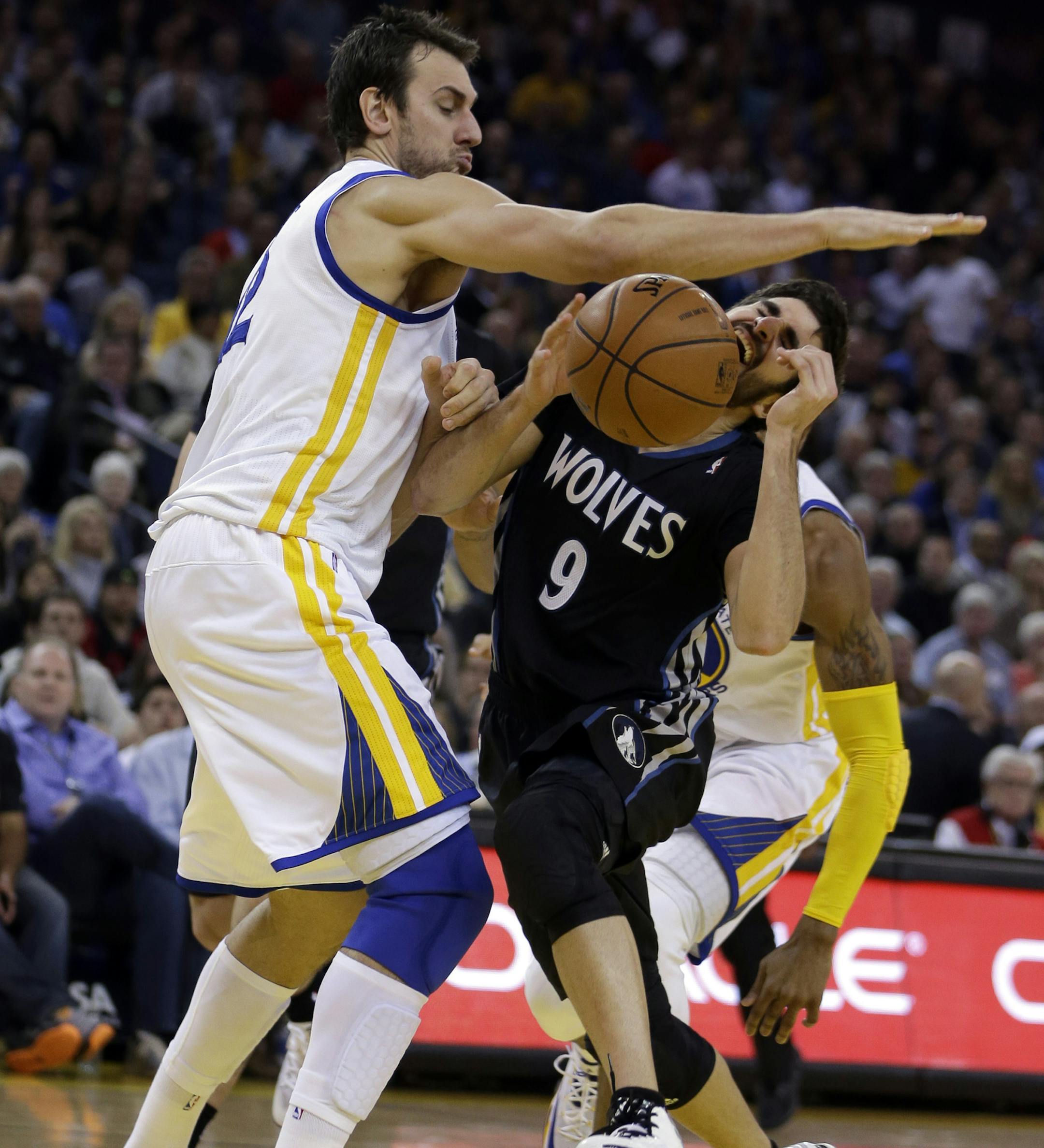 Golden State Warriors' Andrew Bogut, left, blocks the shot of Minnesota Timberwolves' Ricky Rubio (9) during the second half of an NBA basketball game Friday, Jan. 24, 2014, in Oakland, Calif. (AP Photo/Ben Margot)