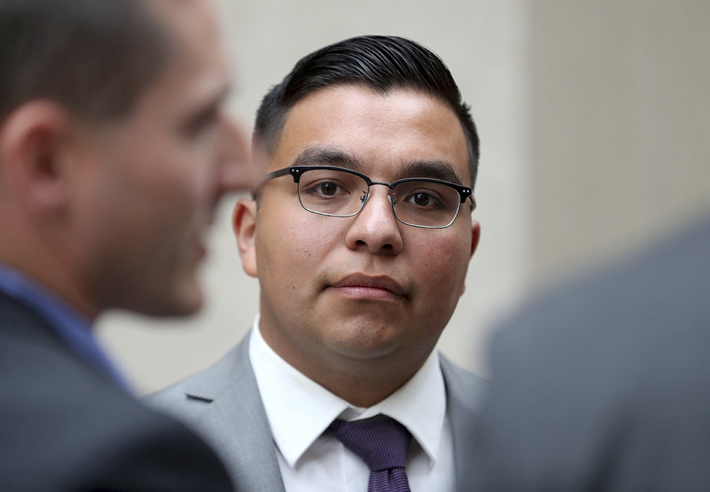 FILE - In this May 30, 2017, file photo, St. Anthony police officer Jeronimo Yanez stands outside the Ramsey County Courthouse while waiting for a ride in St. Paul, Minn. It was announced Monday, July 10, that Yanez, the Minnesota police officer acquitted in last year's fatal shooting of black motorist Philando Castile, has left the police department where he served. (David Joles/Star Tribune via AP, File)