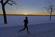 Angela Gustafson braved the -13 degree temperatures for a run around Lake Harriet at sunrise, Tuesday, January 28, 2014 in Minneapolis, MN. (ELIZABETH