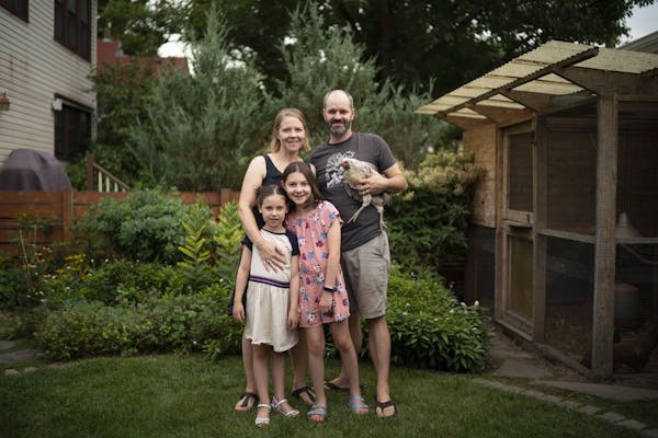 Christina and Stephen McHenry with their daughters, Eloise, 6, and Harriet, 10, and one of their chickens, named Guppy. After their south Minneapolis 