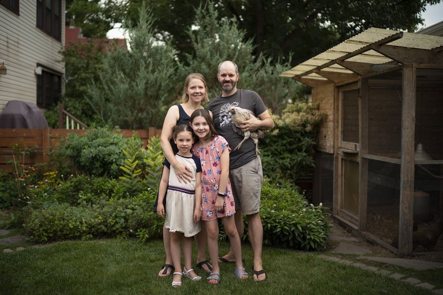 Christina and Stephen McHenry with their daughters, Eloise, 6, and Harriet, 10, and one of their chickens, named Guppy. After their south Minneapolis neighborhood was disrupted by protests and riots this summer, the family began hosting concerts in their yard and garden to bring people together.