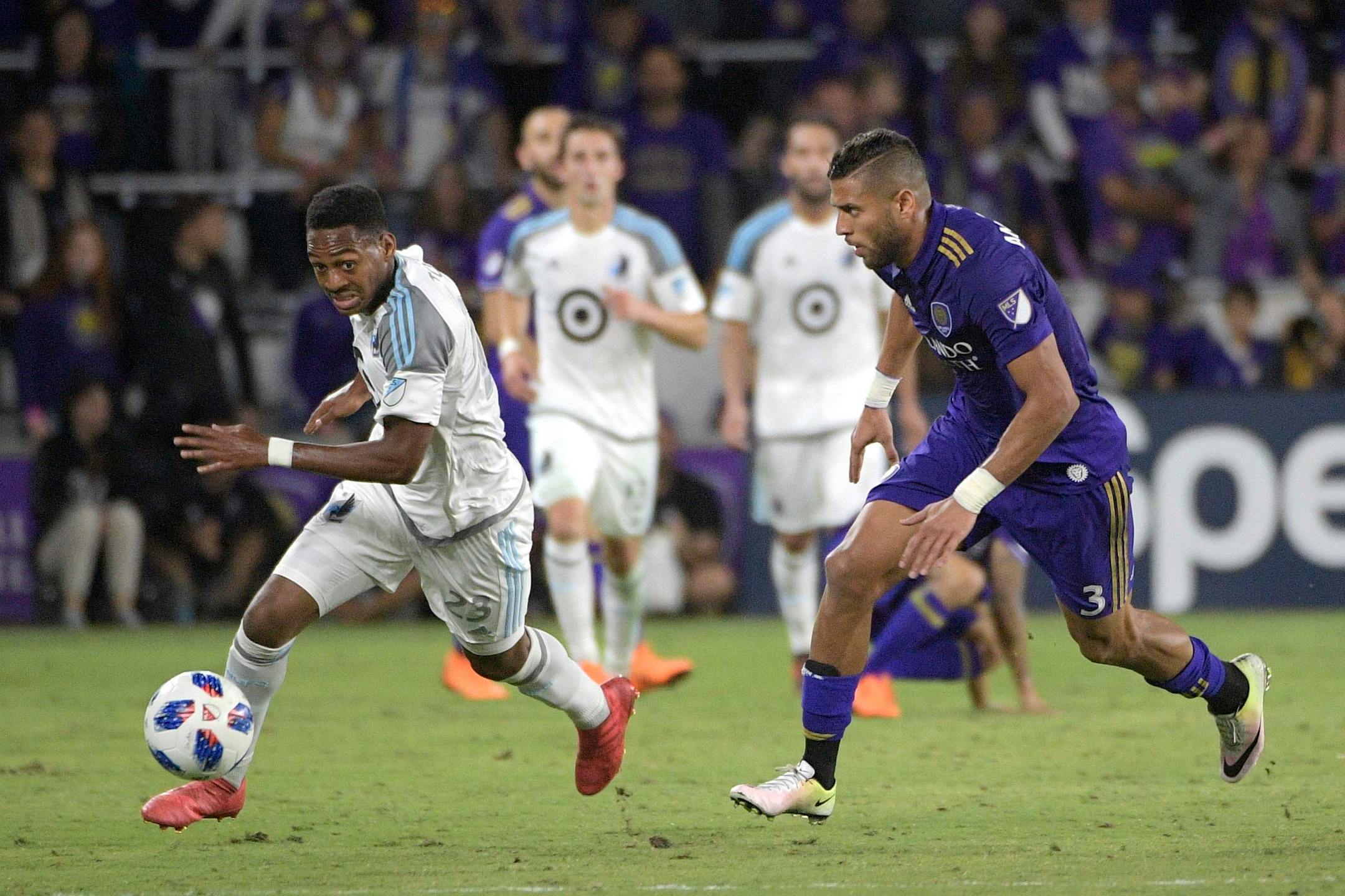 Minnesota United forward Mason Toye (23) pushes the ball in front of Orlando City defender Amro Tarek (3) during the second half of an MLS soccer match Saturday, March 10, 2018, in Orlando, Fla. Minnesota won 2-1. (Phelan M. Ebenhack for the Star-Tribune) ORG XMIT: OTKMINN113