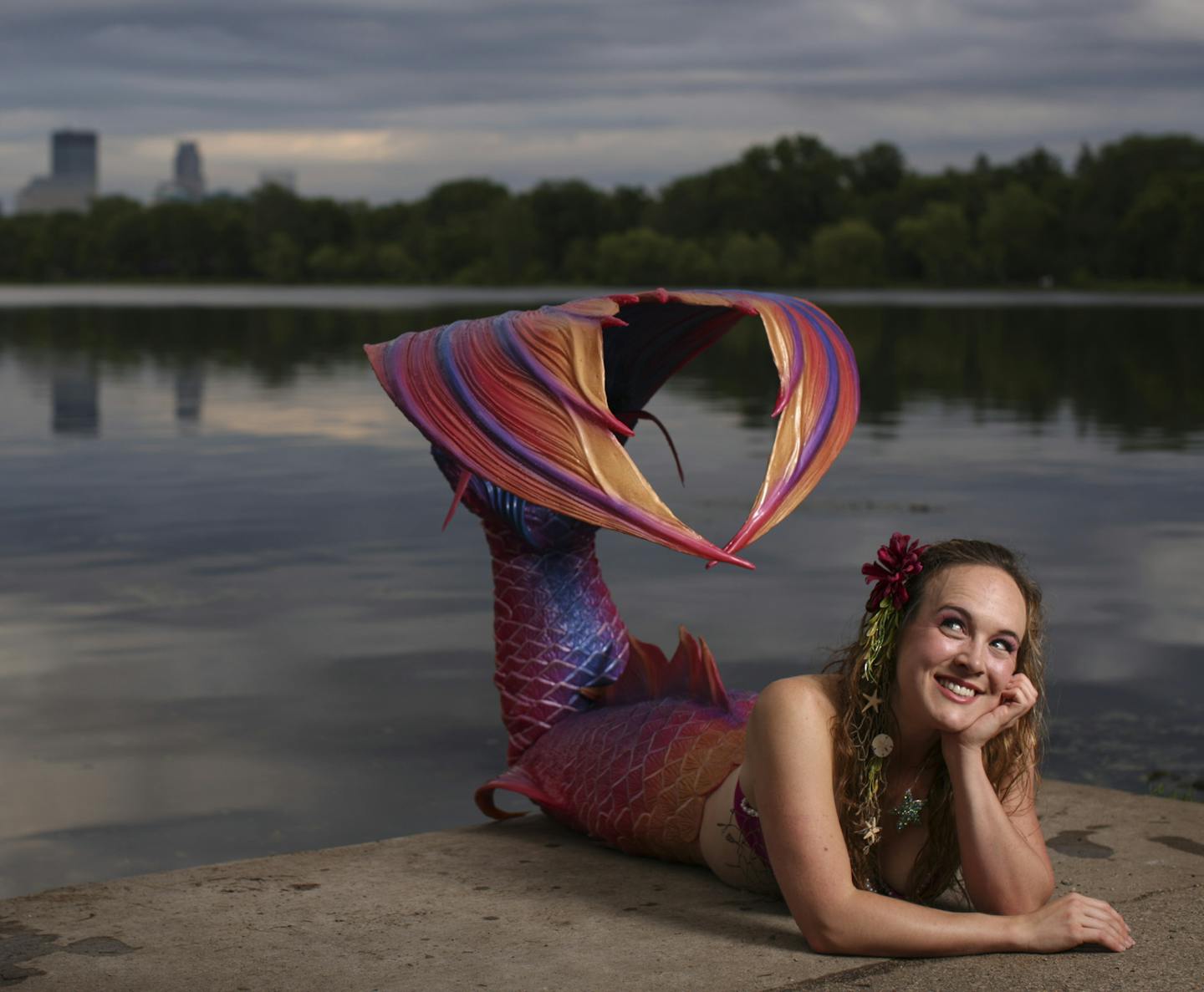 Allie Causin on the shore of Lake of the Isles earlier this month in the mermaid tail she purchased from Bryn and Abby Roberts at Finfolk Productions. ] JEFF WHEELER &#x201a;&#xc4;&#xa2; jeff.wheeler@startribune.com In "The Little Mermaid," Ariel wants to ditch her fins in favor of feet. The opposite is true for mermaid hobbyists, willing to pay $2,500 or more for a custom mermaid tail from Minnesota-based Finfolk Productions. Allie Causlin was photographed Thursday evening, June 5, 2014 on the