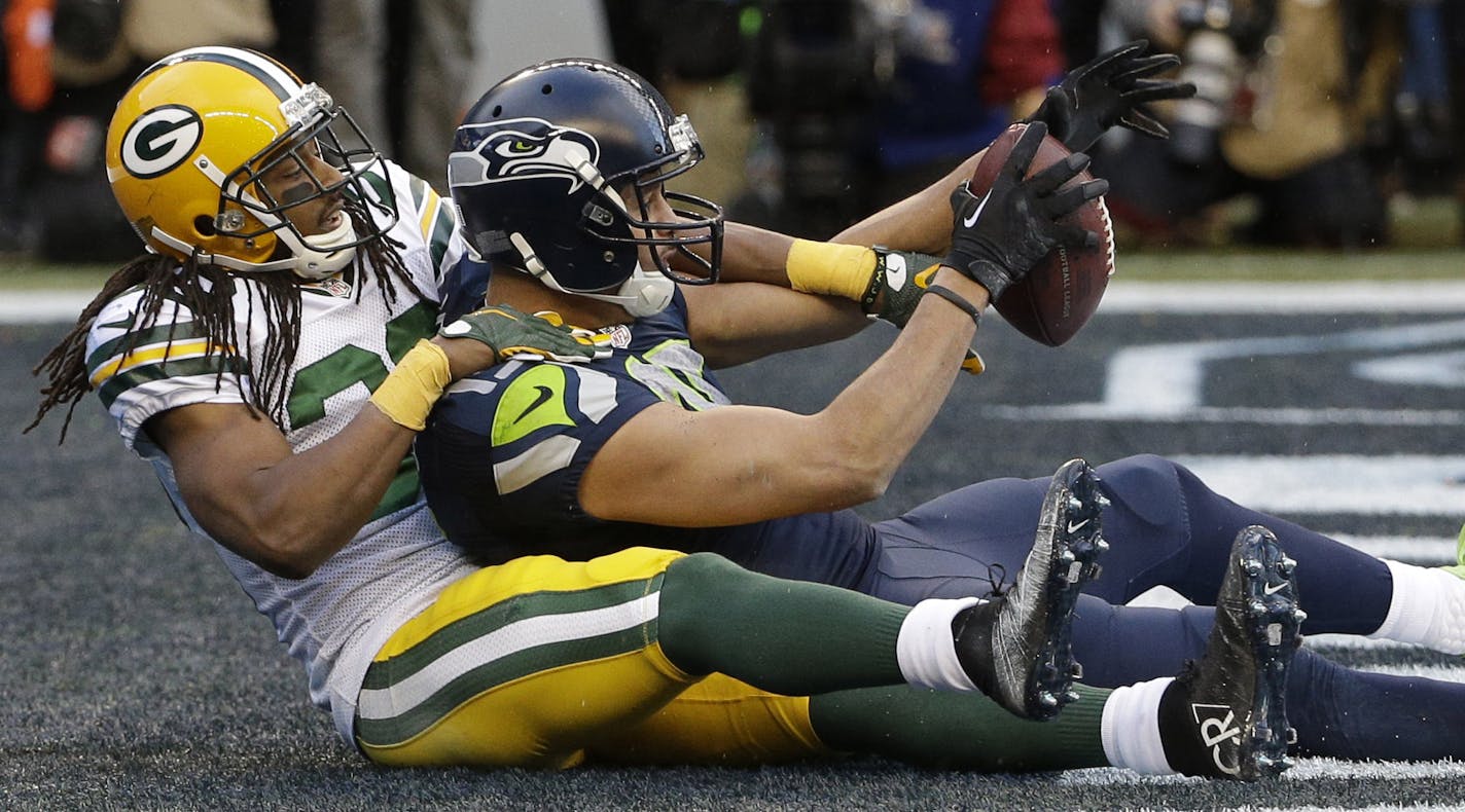 Seattle Seahawks' Jermaine Kearse catches the game-winning touchdown pass in front of Green Bay Packers' Tramon Williams during overtime of the NFL football NFC Championship game Sunday, Jan. 18, 2015, in Seattle. The Seahawks won 28-22 to advance to Super Bowl XLIX. (AP Photo/David J. Phillip)