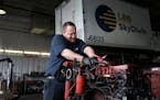 Global Aviation Services mechanic Bob Walker works to remove an engine strap to put on a new diesel engine he was going to install in a catering truck