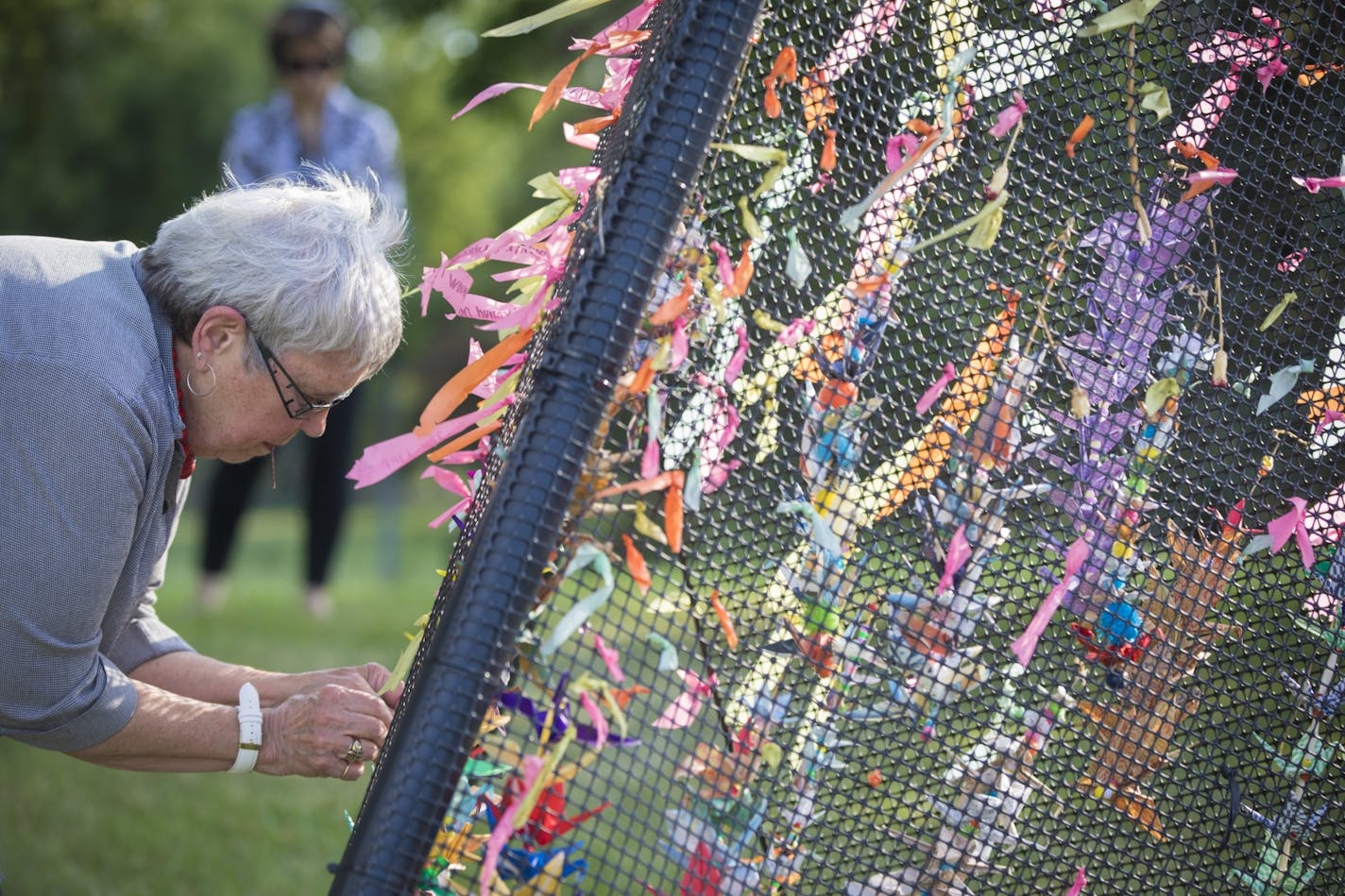 Judy Baldwin, who lives near where Philando Castile was killed in Falcon Heights one year ago, has been bringing 10 cranes a day to the scene to form a memorial. Thursday was the anniversary of Castile's shooting death by a St. Anthony police officer.