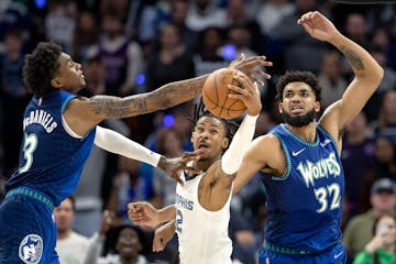 Memphis guard Ja Morant drove between Jaden McDaniels (3) and Karl Anthony-Towns (32) of the Timberwolves in Game 6 of last season’s first-round pla