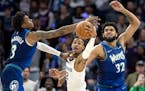 Memphis guard Ja Morant drove between Jaden McDaniels (3) and Karl Anthony-Towns (32) of the Timberwolves in Game 6 of last season’s first-round pla