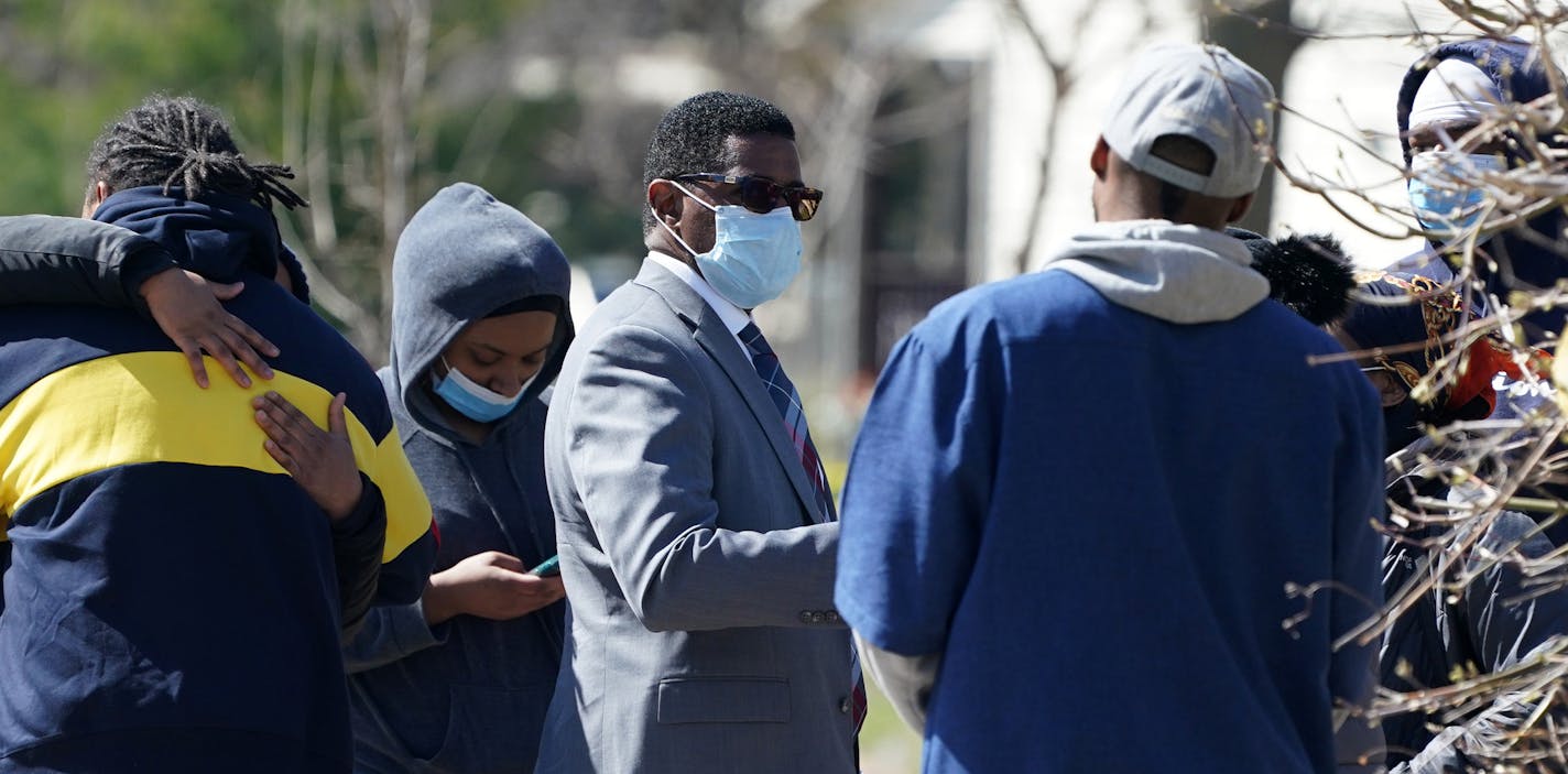 Sgt. Christopher Gaiters, center, talked with bystanders at the scene of a homicide Saturday in the 1100 block of Irving Avenue North. ] ANTHONY SOUFFLE &#x2022; anthony.souffle@startribune.com Police investigated the scene of a homicide Saturday, April 18, 2020 in the 1100 block of Irving Avenue North in Minneapolis.