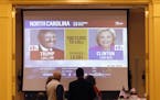 In this Tuesday, Nov. 8, 2016 photo, supporters watch as results come in at the a GOP election party in Cedar Falls, Iowa. Donald Trump&#xed;s stunnin