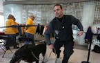 Dan Hughs, CEO of Dog Defense, worked with his German shepherd, Adak, to ensure the safety of those attending an event at a downtown Minneapolis skysc