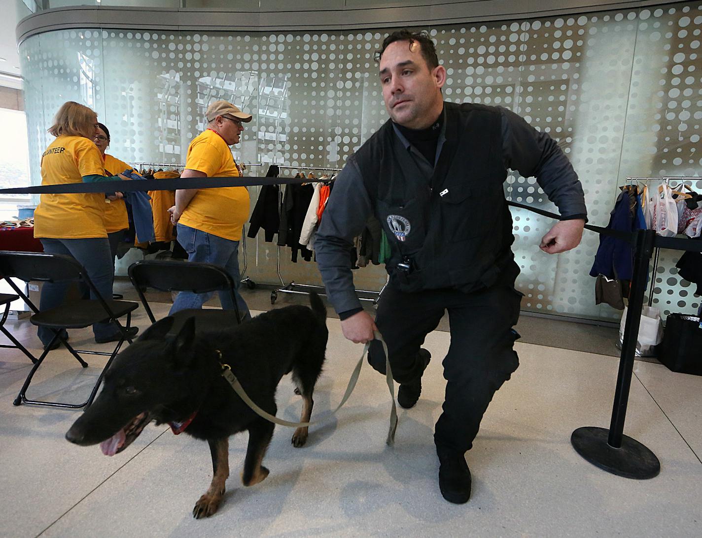 Dan Hughs, CEO of Dog Defense, worked with his German shepherd, Adak, to ensure the safety of those attending an event at a downtown Minneapolis skyscraper recently. Hughs used the dog to sweep areas in the building to make sure that there were no explosives present. ] JIM GEHRZ &#xef; james.gehrz@startribune.com / Minneapolis, MN / February 6, 2016 /9:30 AM &#xf1; BACKGROUND INFORMATION: A St. Cloud company that specializes in providing dogs for explosive detection has made a pivot with the tim