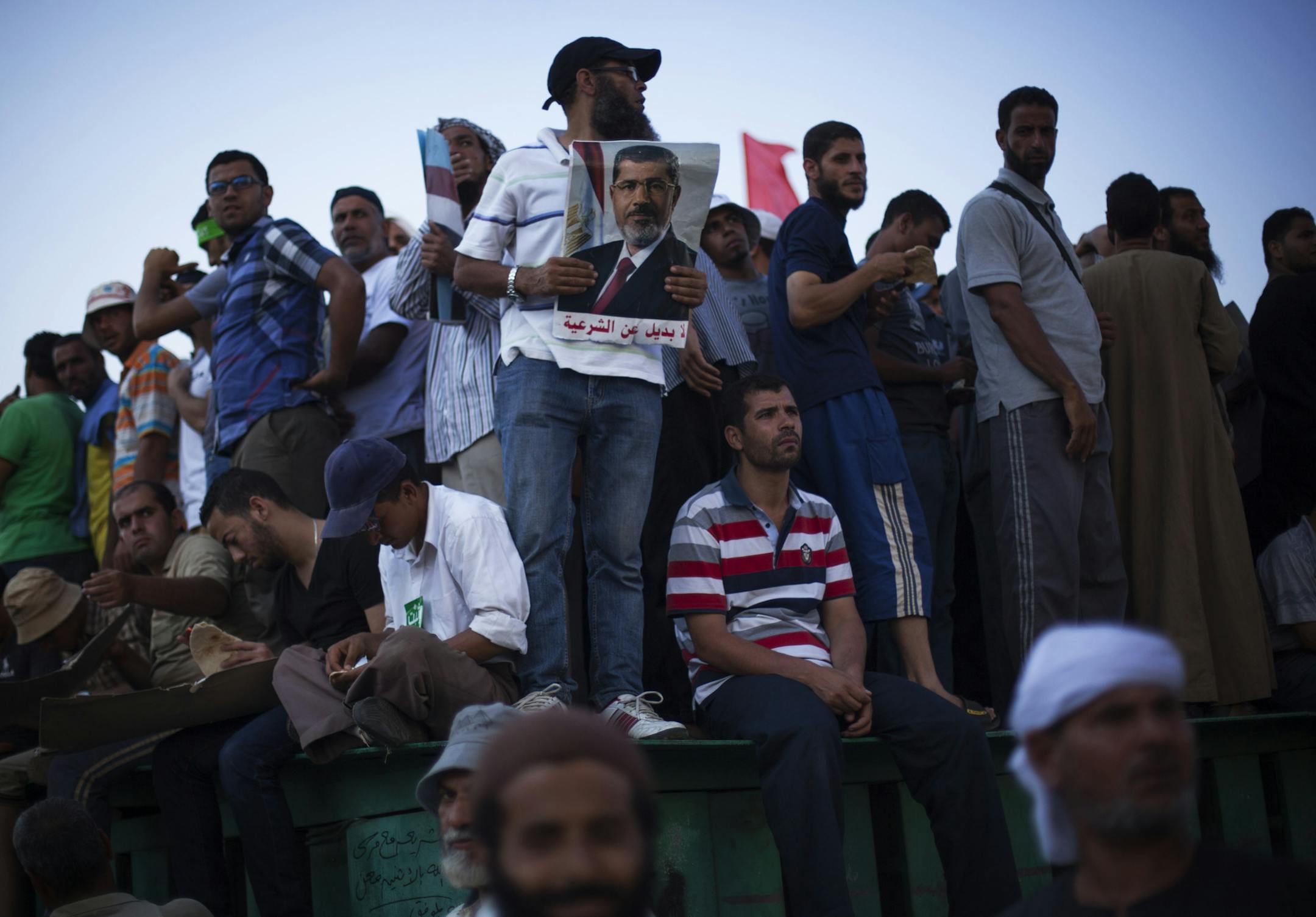 Supporters of Egypt's ousted President Mohammed Morsi are seen during a protest outside the Republican Guard building in Cairo, Egypt, Sunday, July 7, 2013. . Egypt's new leadership wrangled over the naming of a prime minister, as both the Muslim Brotherhood and their opponents called for new mass rallies Sunday, renewing fears of another round of street violence over the military's ousting of Islamist President Mohammed Morsi. The calls for competing rallies come after clashes two days ago betw