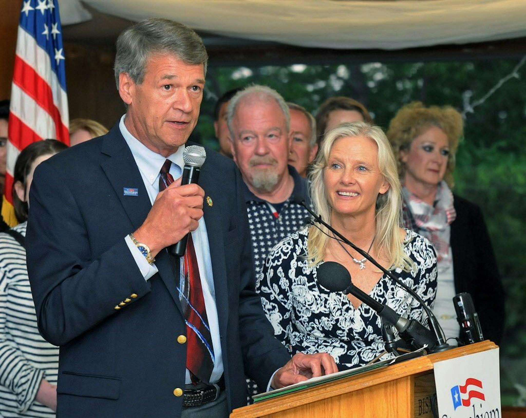 North Dakota Attorney General Wayne Stenehjem announces he is conceding the race for governor to Doug Burgum at a Republican Party gathering in Bismarck, N.D., Tuesday, June 14, 2016. At right is Stenehjem's wife, Beth. (Tom Stromme/The Bismarck Tribune via AP) MANDATORY CREDIT