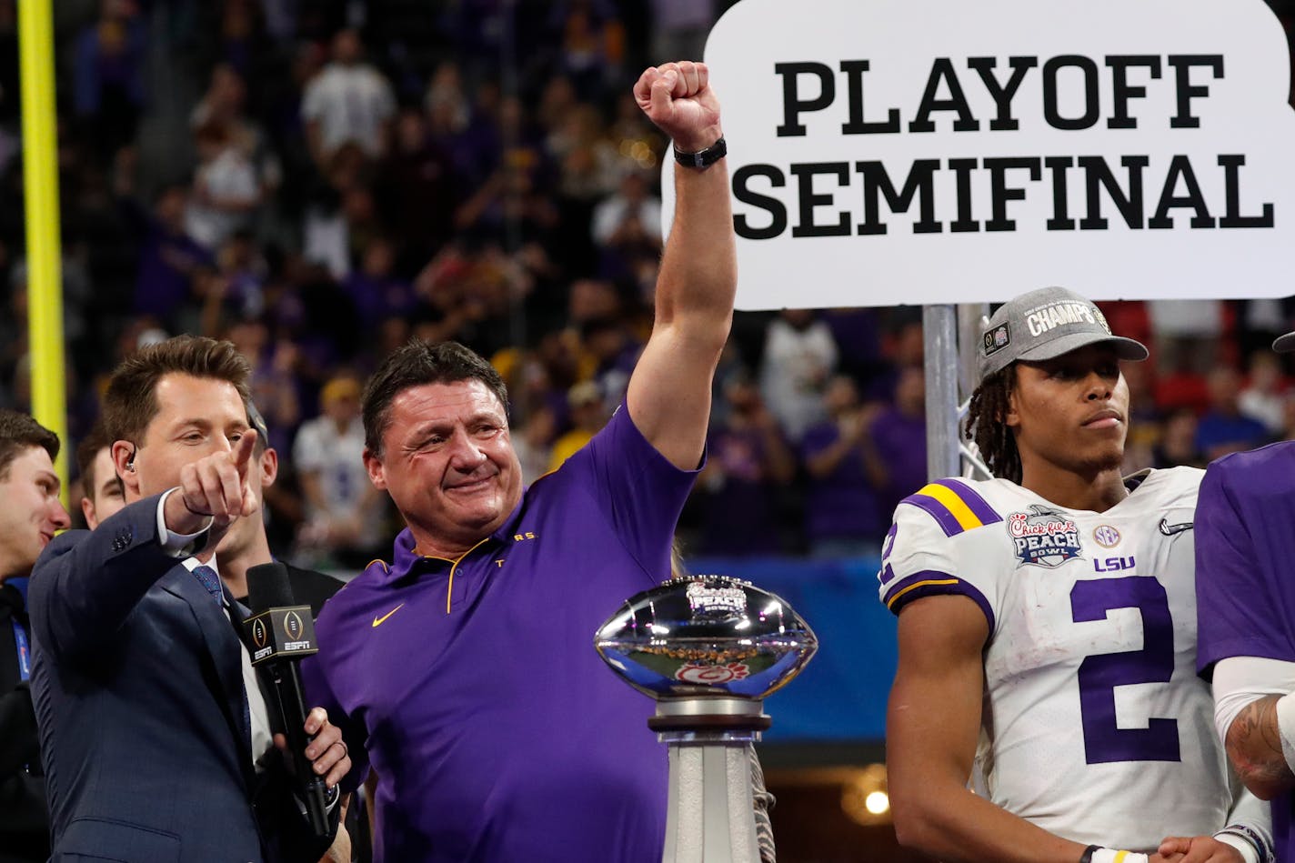 LSU coach Ed Orgeron and the Tigers celebrated winning the Peach Bowl playoff game against Oklahoma on Dec. 28