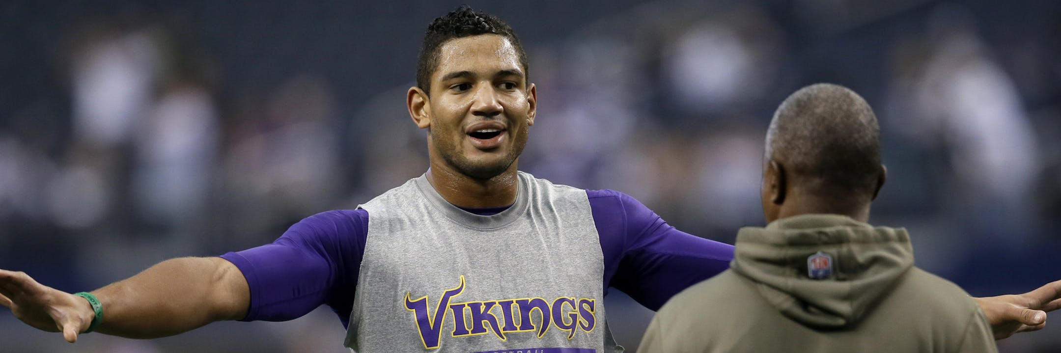 Minnesota Vikings quarterback Josh Freeman, left, talks with a member of the staff as he warms up before an NFL football game against the Dallas Cowboys, Sunday, Nov. 3, 2013, in Arlington, Texas. (AP Photo/Tim Sharp) ORG XMIT: MIN2013112517554180